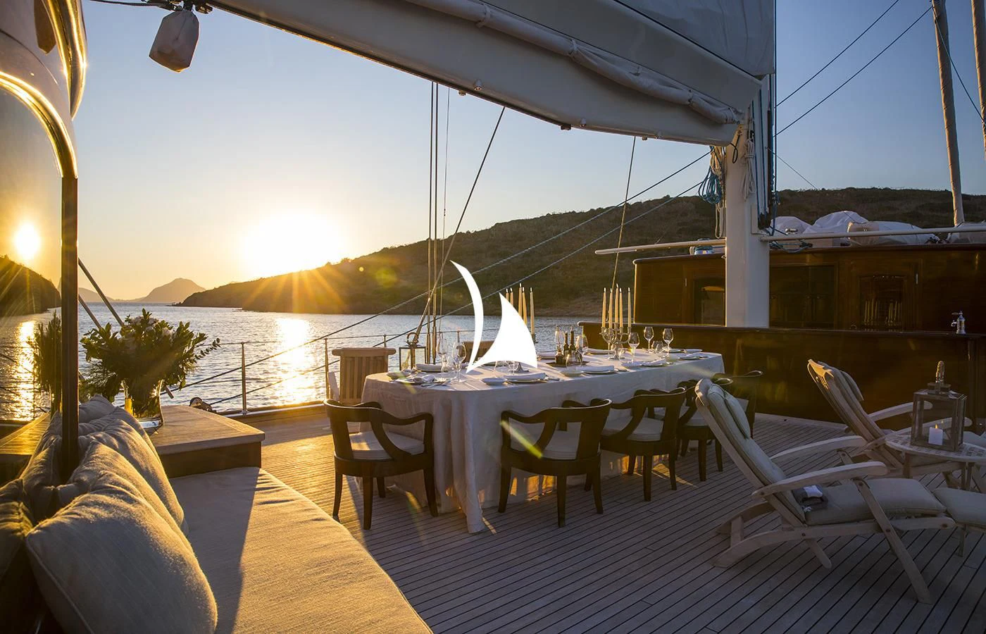 a deck with a table and chairs aboard SATORI Yacht for Charter