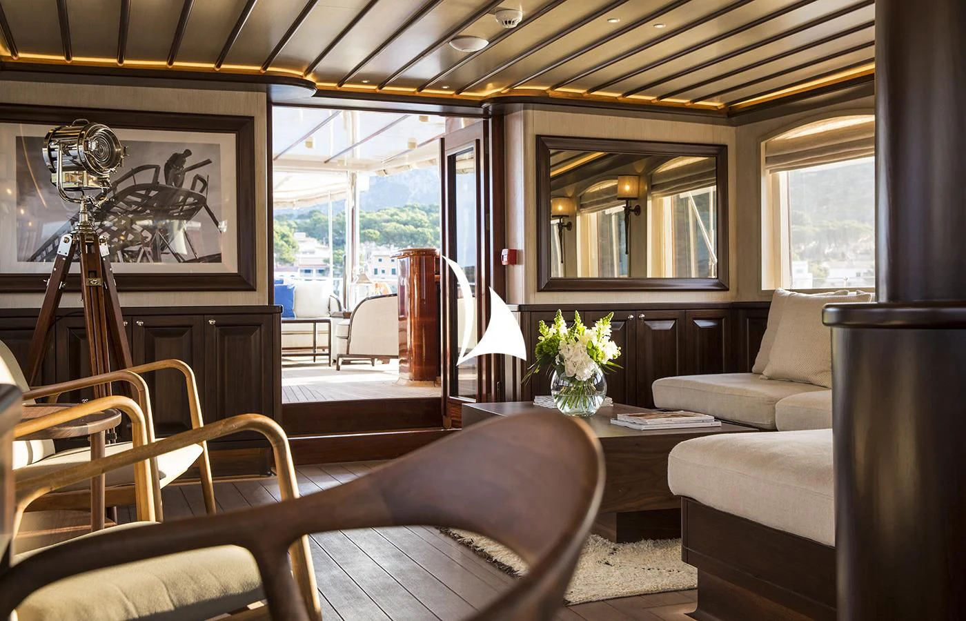 a living room with a glass window aboard SATORI Yacht for Charter