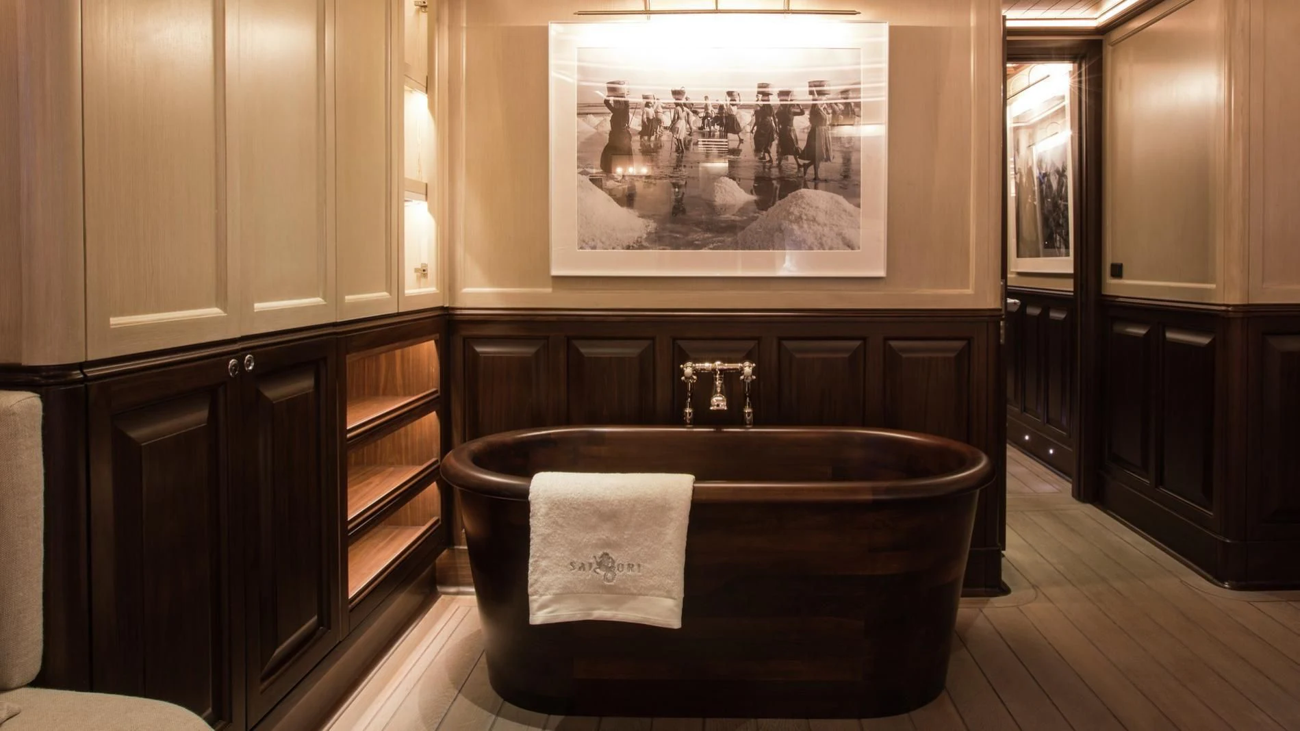 a large room with wooden cabinets and a large mirror aboard SATORI Yacht for Charter