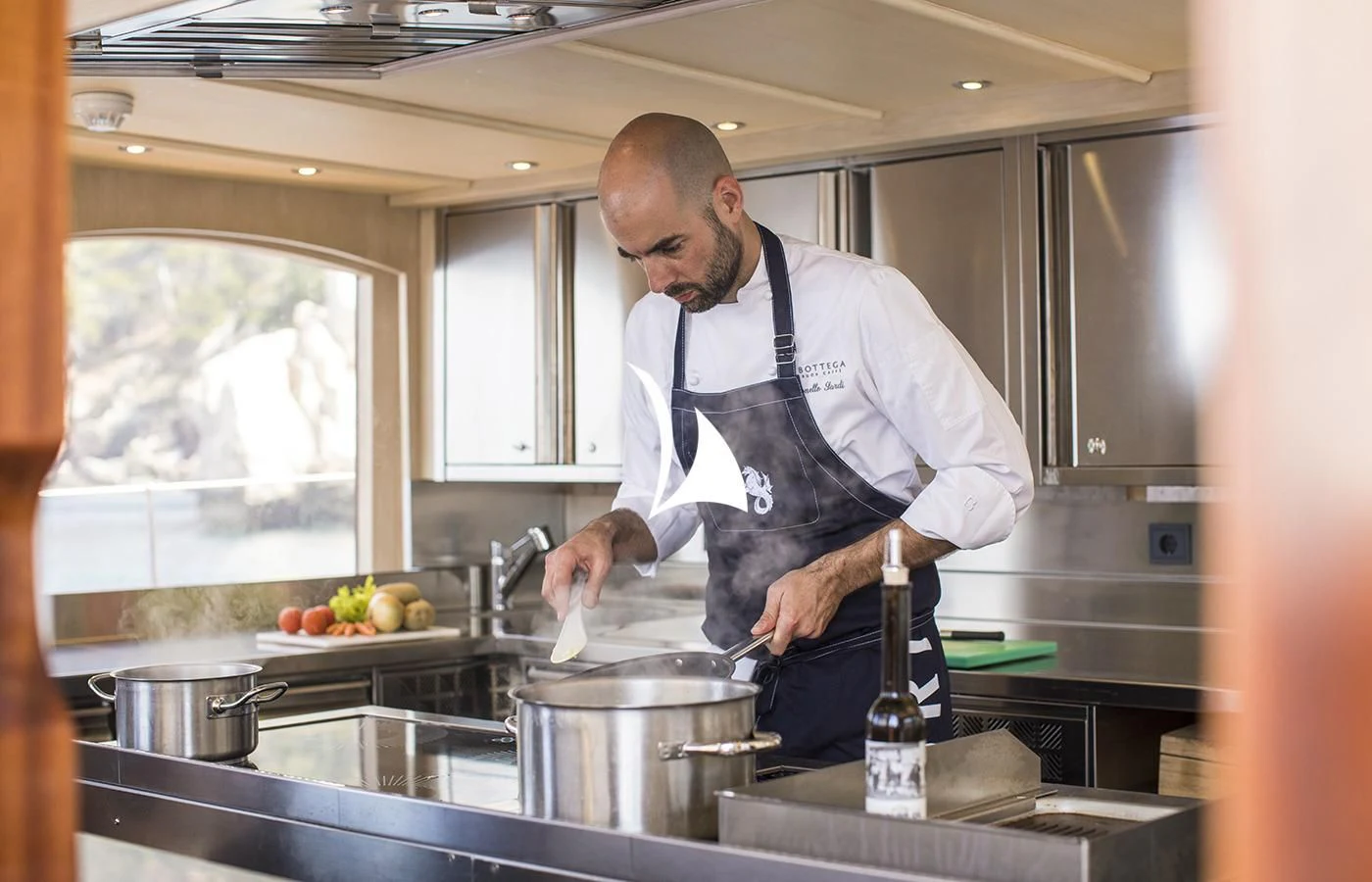 a man in a kitchen aboard SATORI Yacht for Charter