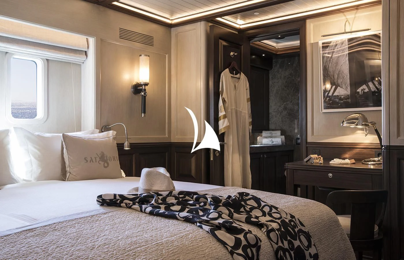 a bedroom with a bed and a lamp aboard SATORI Yacht for Charter