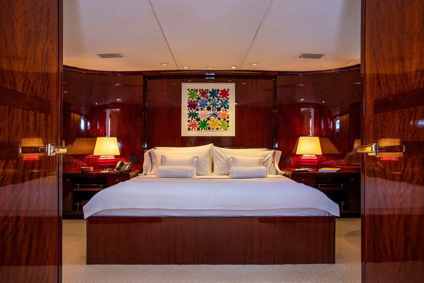 a bed with a white sheet and pillows aboard MIKADO Yacht for Sale