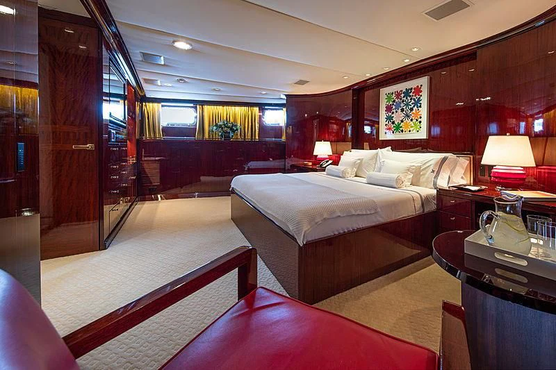 a hotel room with a bed and a table aboard MIKADO Yacht for Sale