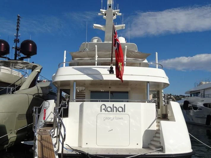 a large white boat with a red and white flag on it aboard RAHAL Yacht for Sale