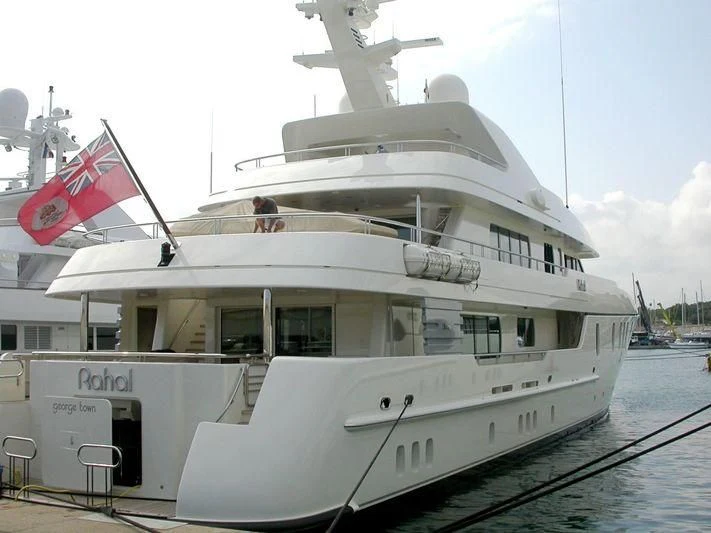 a large white boat with flags on it aboard RAHAL Yacht for Sale