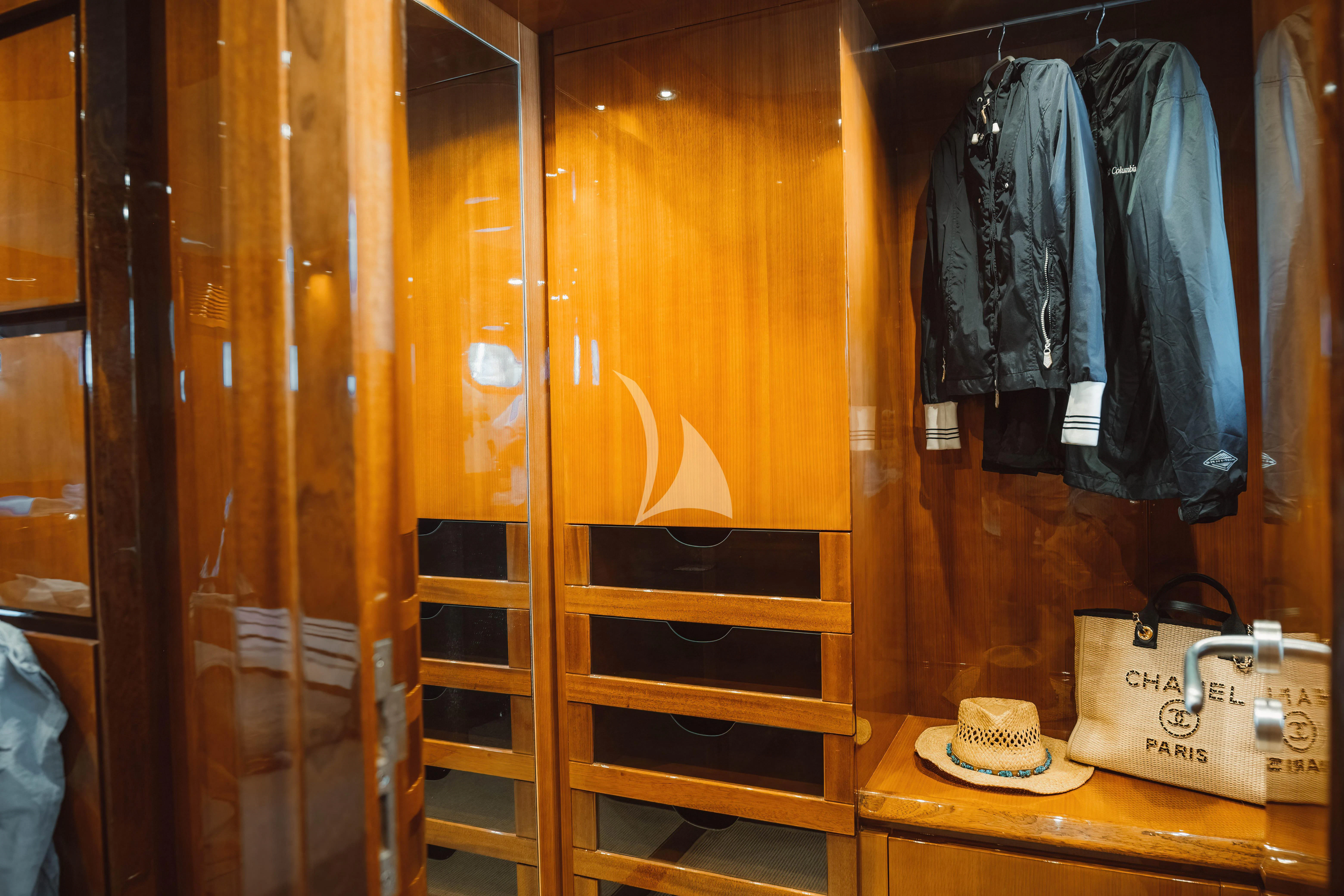 a shelf with clothes and a coffee cup on it aboard MAGIC SIX Yacht for Sale