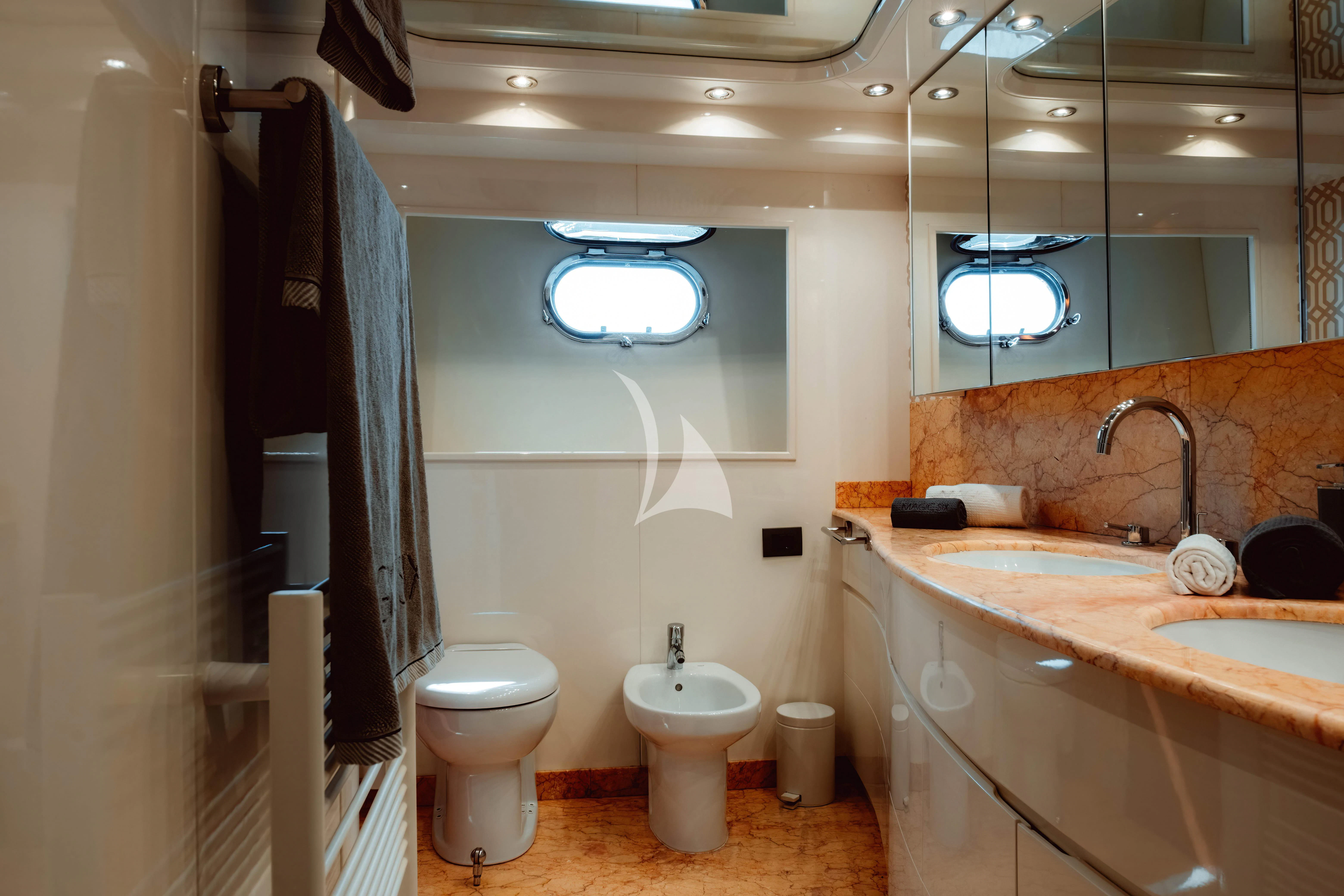 a bathroom with a toilet sink and a bathtub aboard MAGIC SIX Yacht for Sale