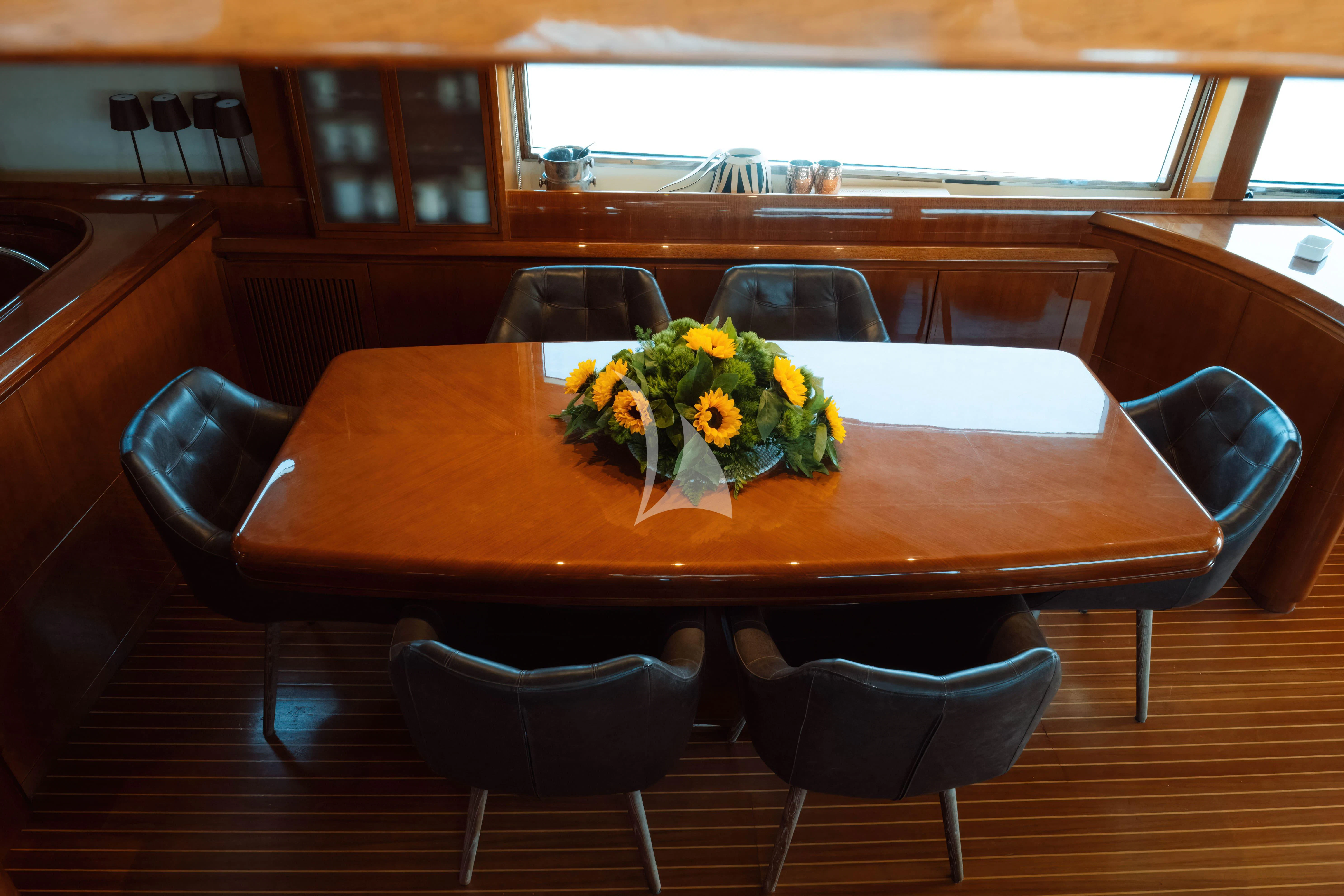 a table with flowers on it aboard MAGIC SIX Yacht for Sale