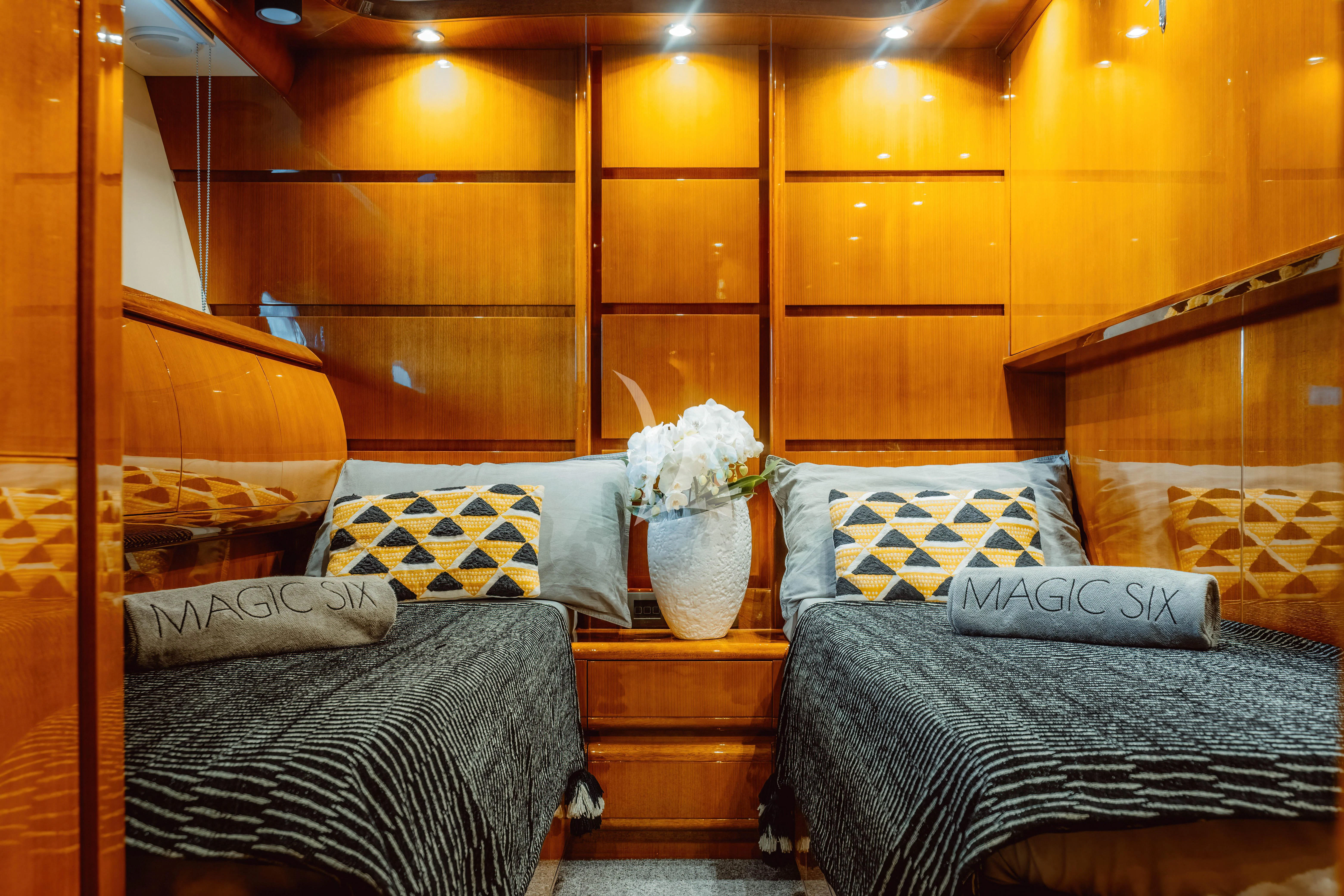 a bed with a flowery pillow aboard MAGIC SIX Yacht for Sale