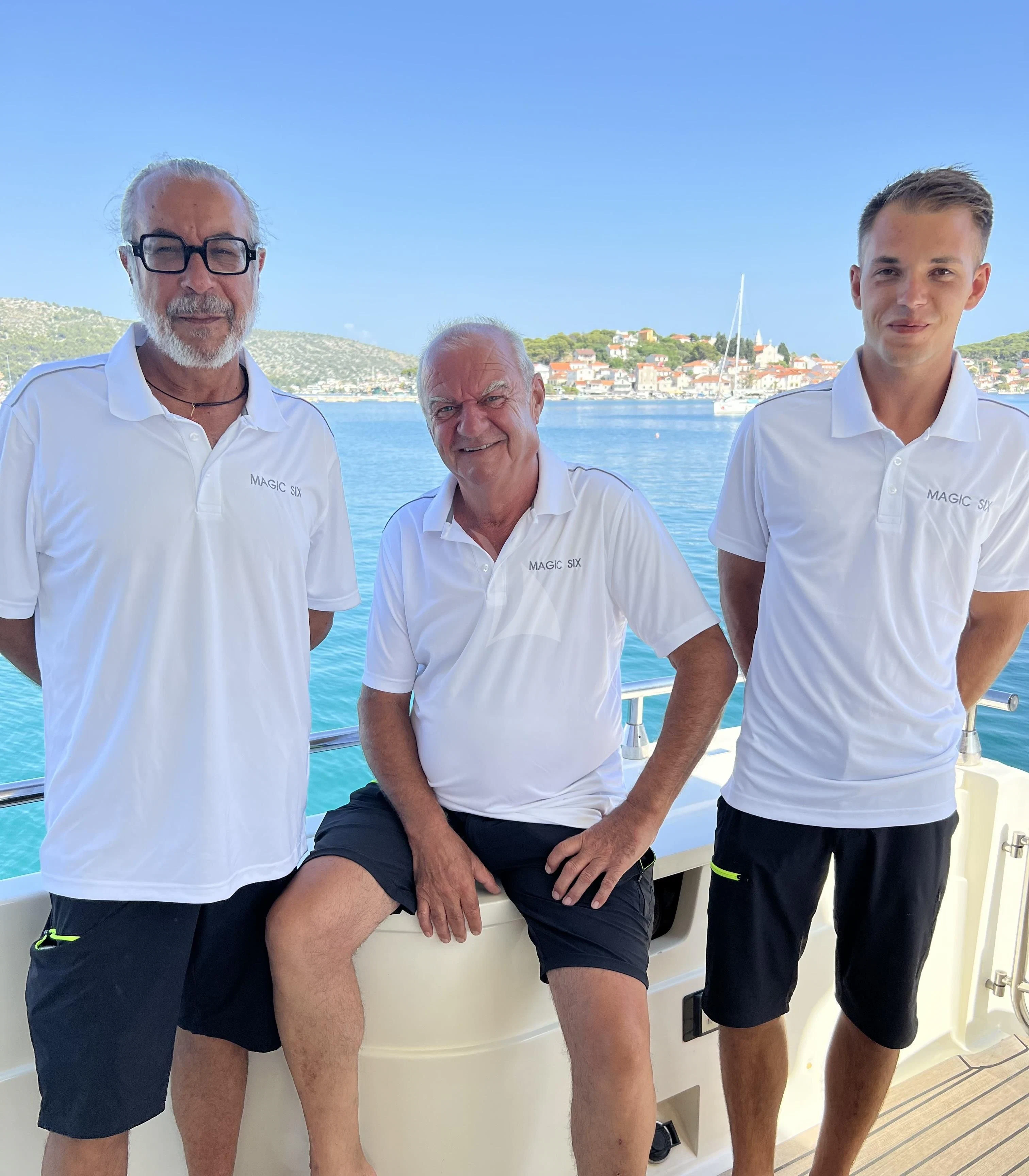 a group of men posing for a photo aboard MAGIC SIX Yacht for Sale