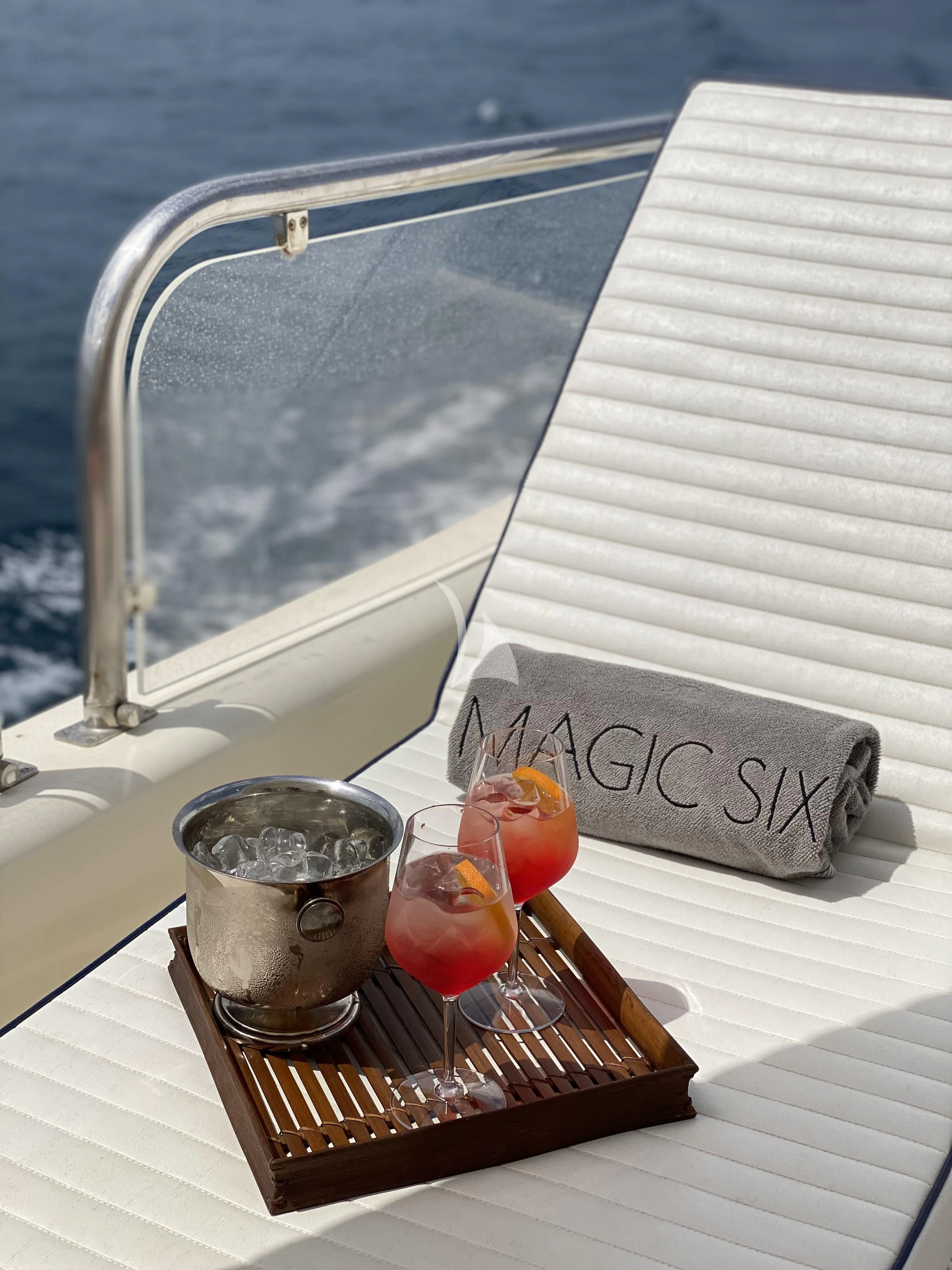 a glass of red juice on a table outside a window aboard MAGIC SIX Yacht for Sale