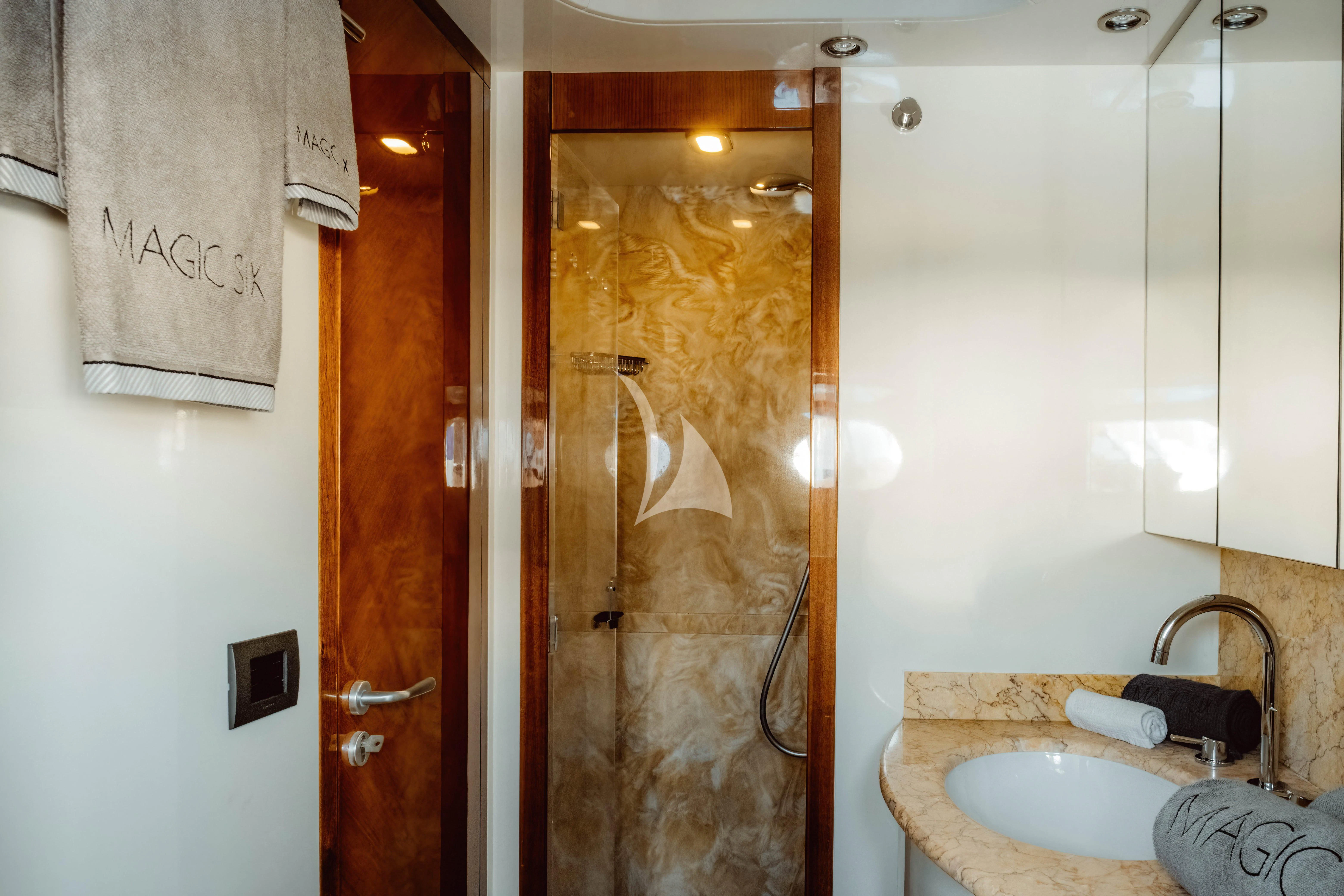 a bathroom with a glass shower door aboard MAGIC SIX Yacht for Sale