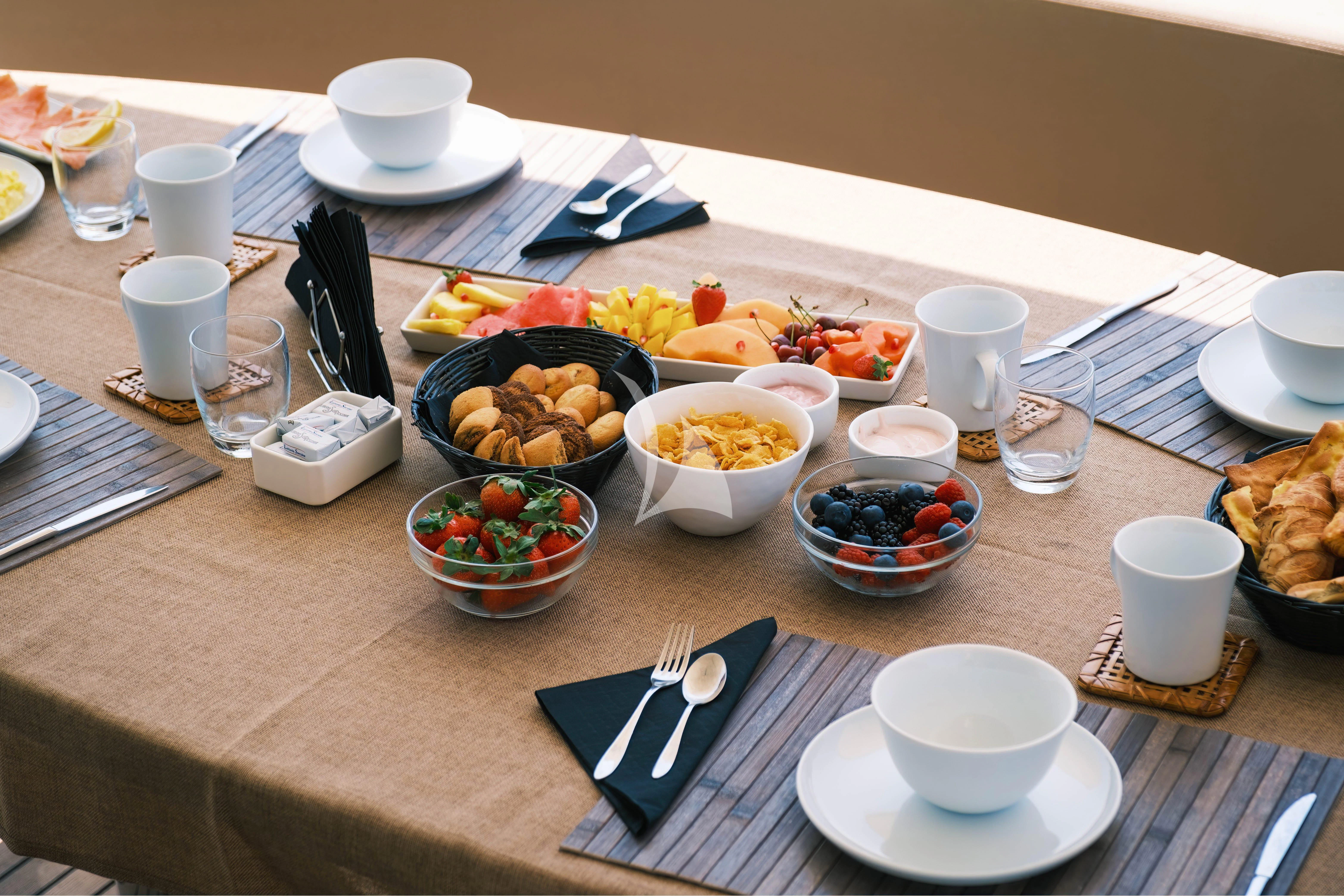 a table with food and drinks aboard MAGIC SIX Yacht for Sale