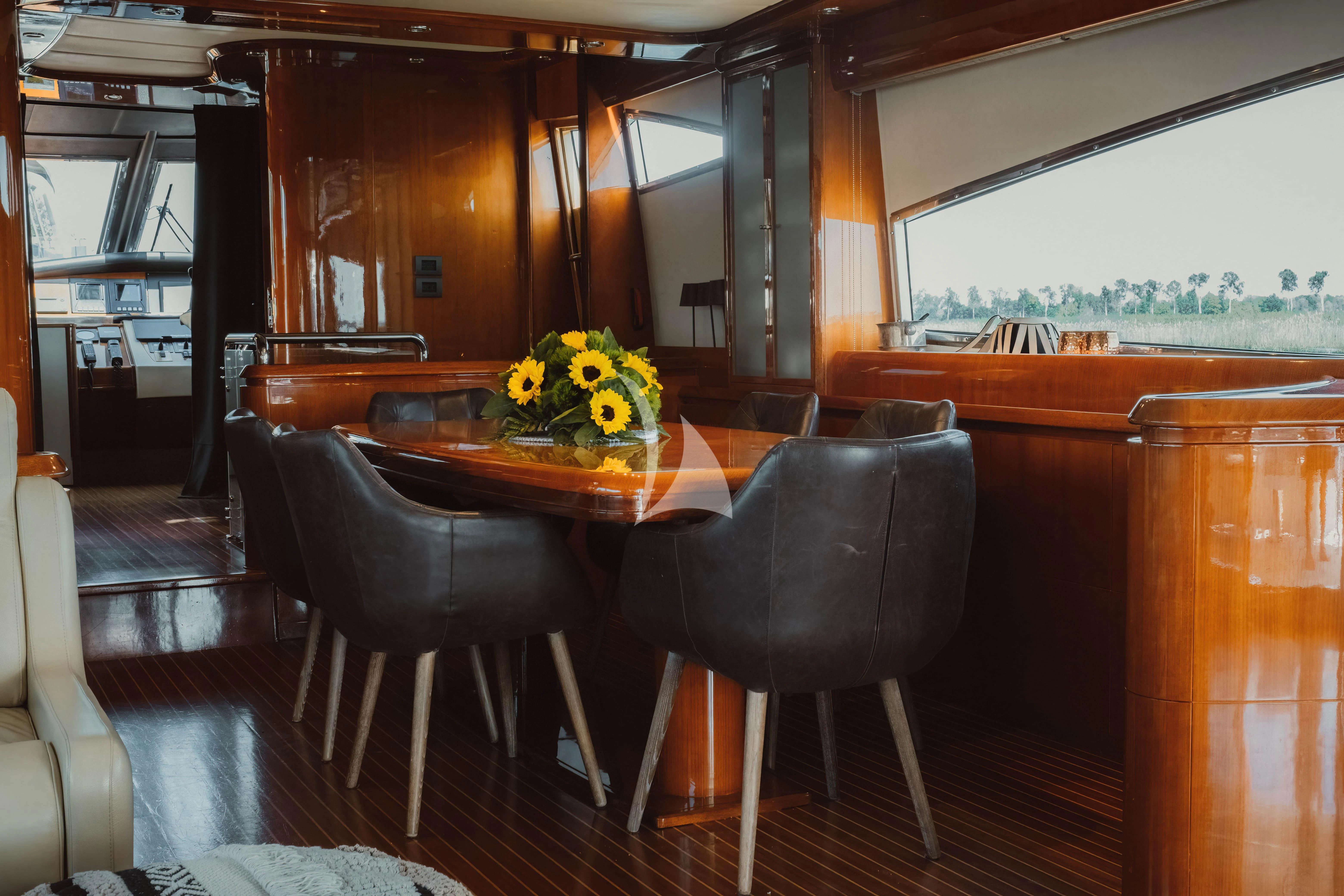a table and chairs in a room aboard MAGIC SIX Yacht for Sale