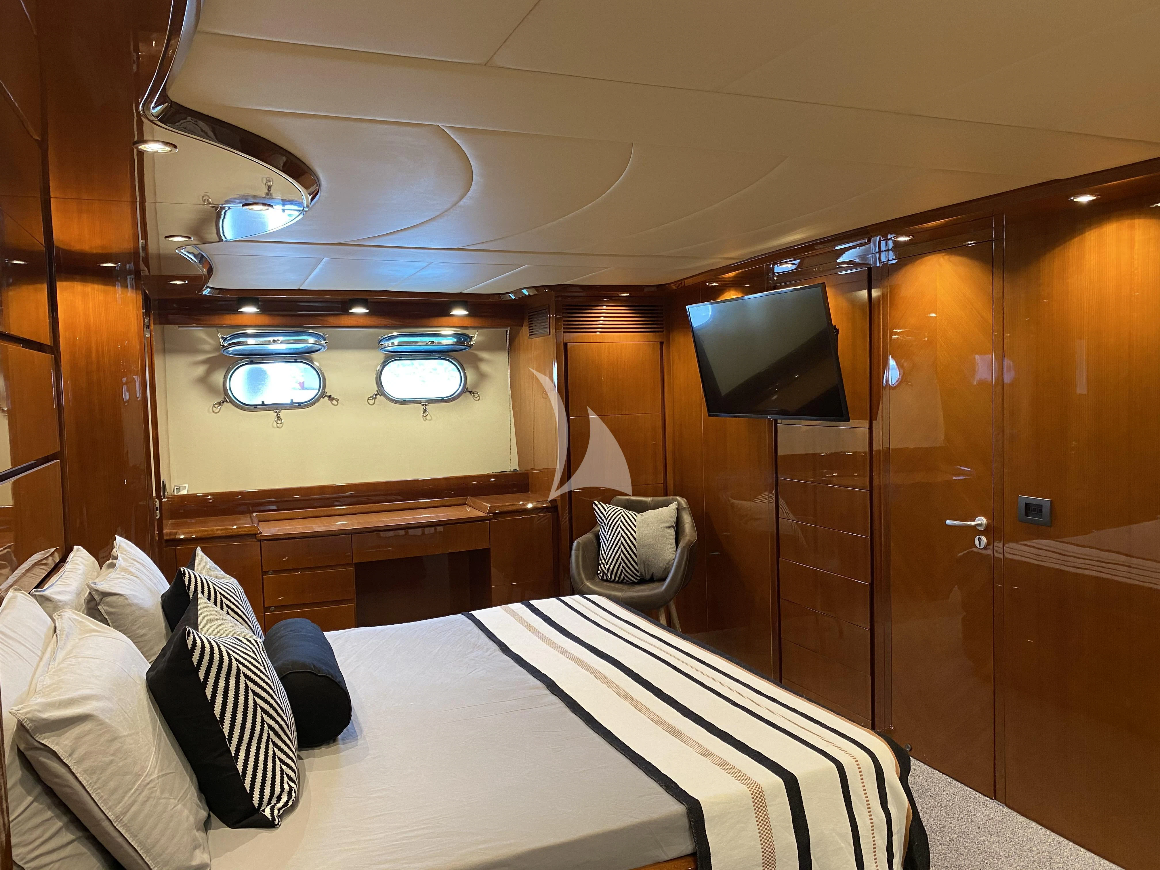 a bed with a white bed spread aboard MAGIC SIX Yacht for Sale