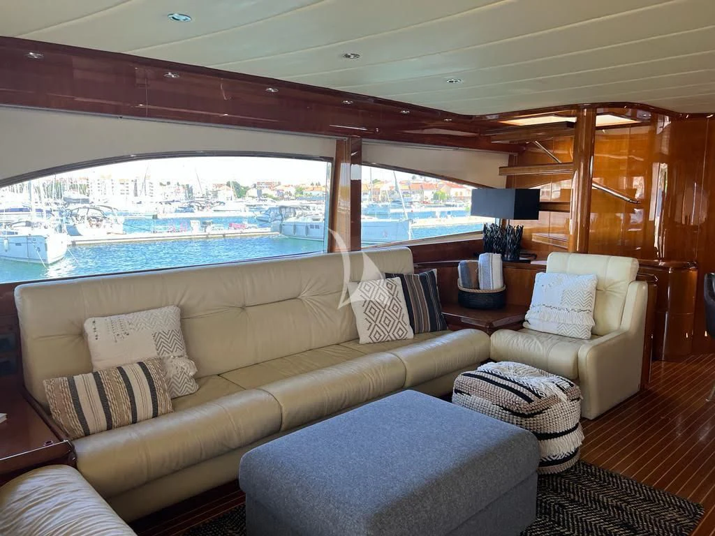 a living room with a large window aboard MAGIC SIX Yacht for Sale