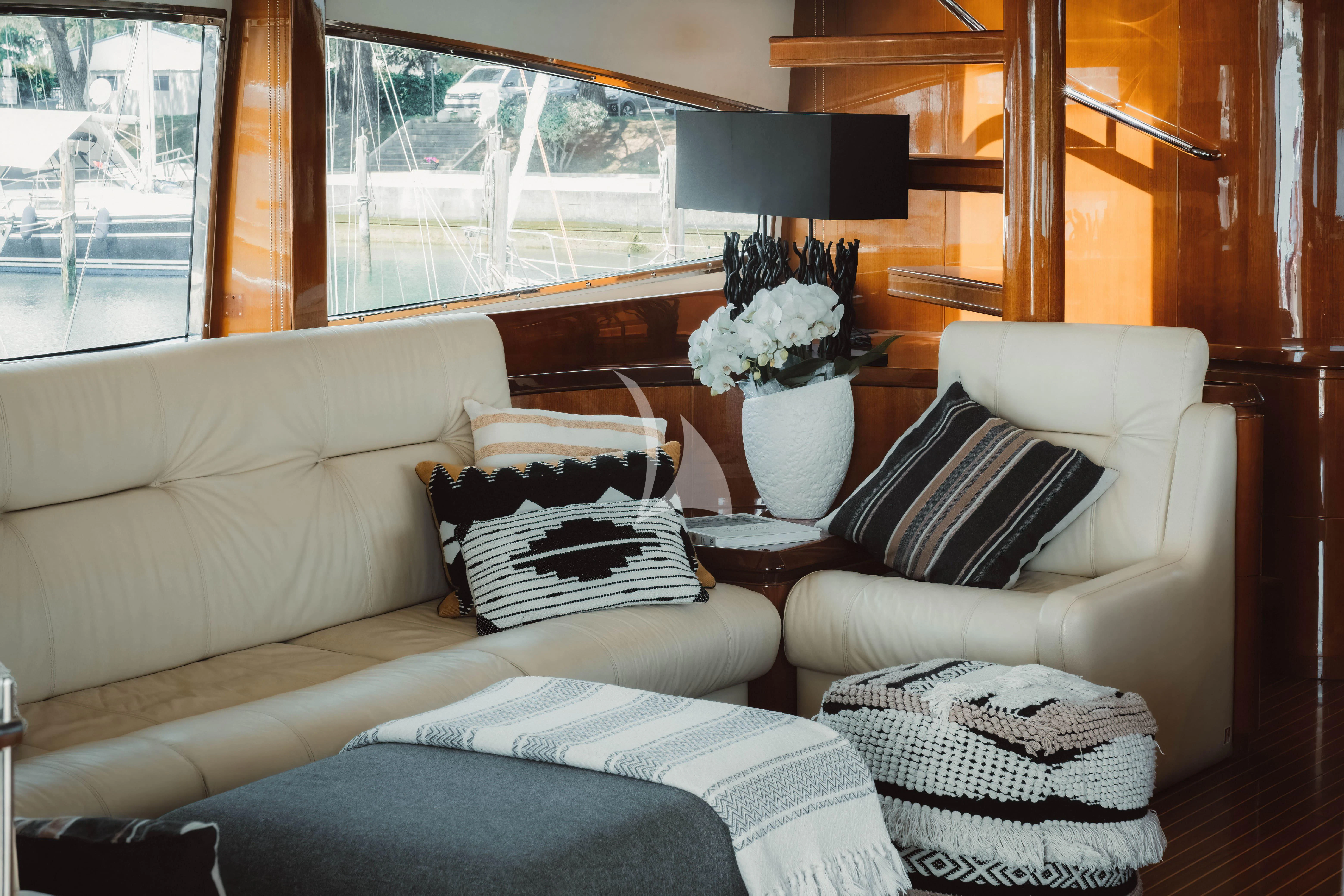 a living room with a couch and a window aboard MAGIC SIX Yacht for Sale