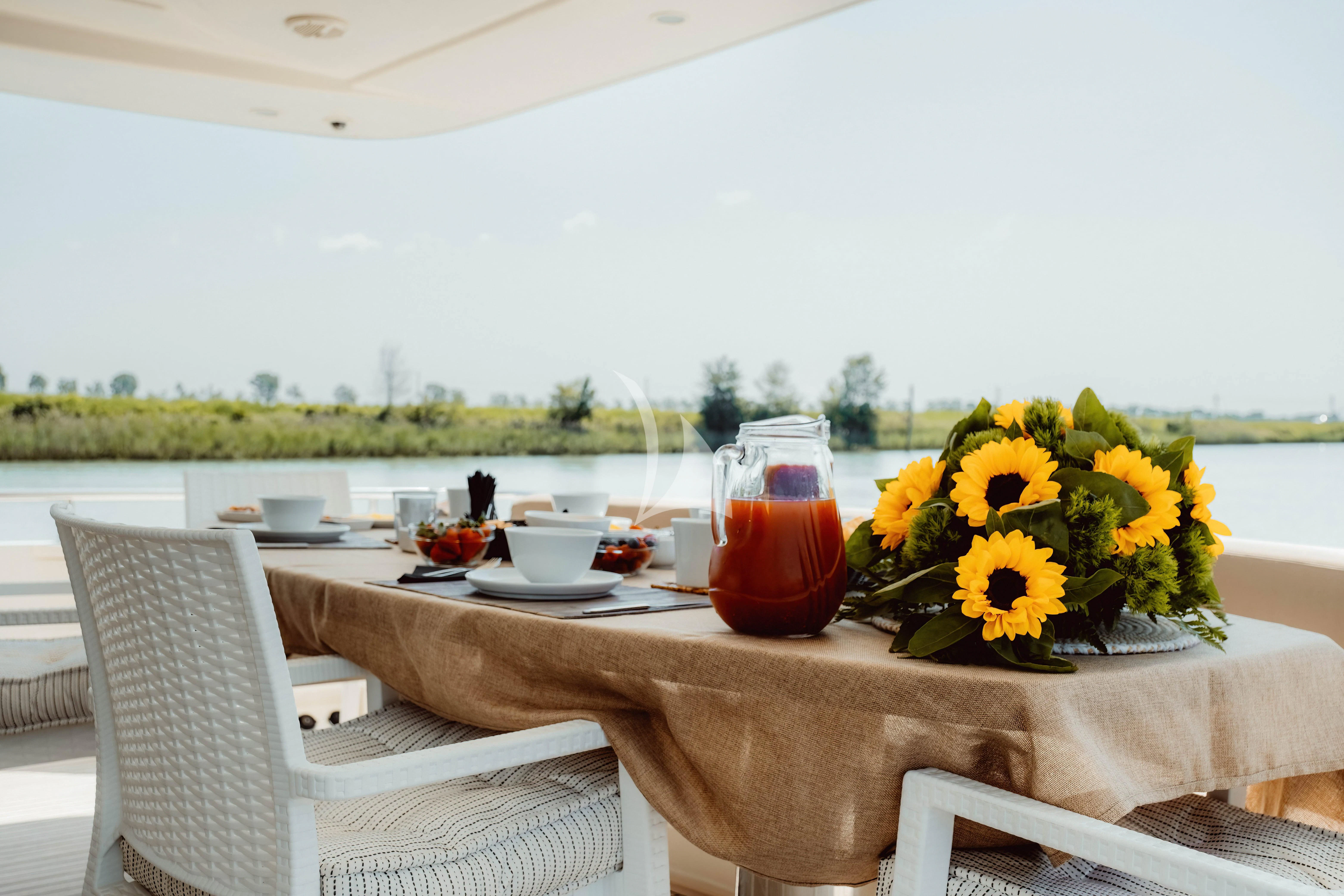 a table with a vase of flowers on it aboard MAGIC SIX Yacht for Sale