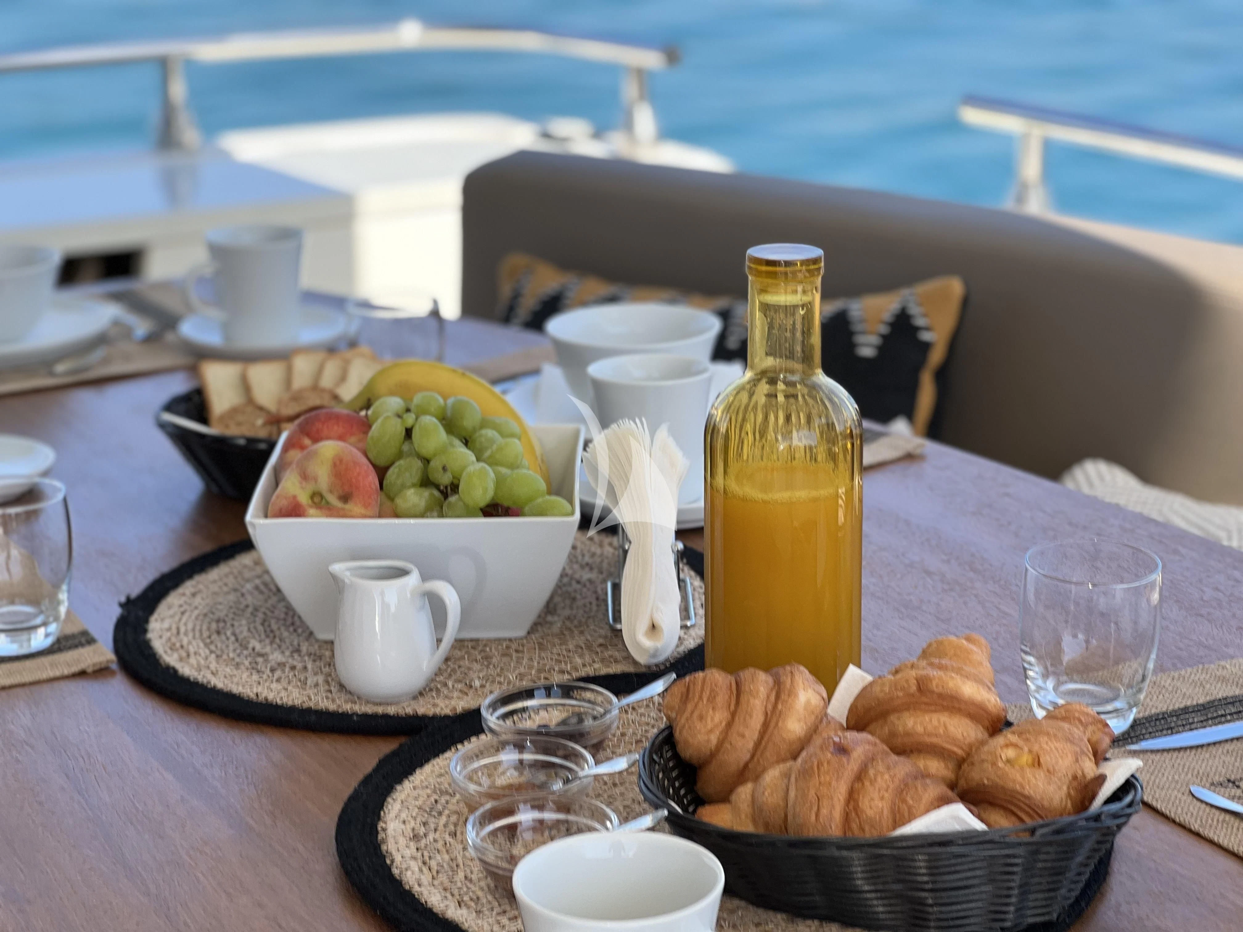 a table with food and drinks on it aboard MAGIC SIX Yacht for Sale