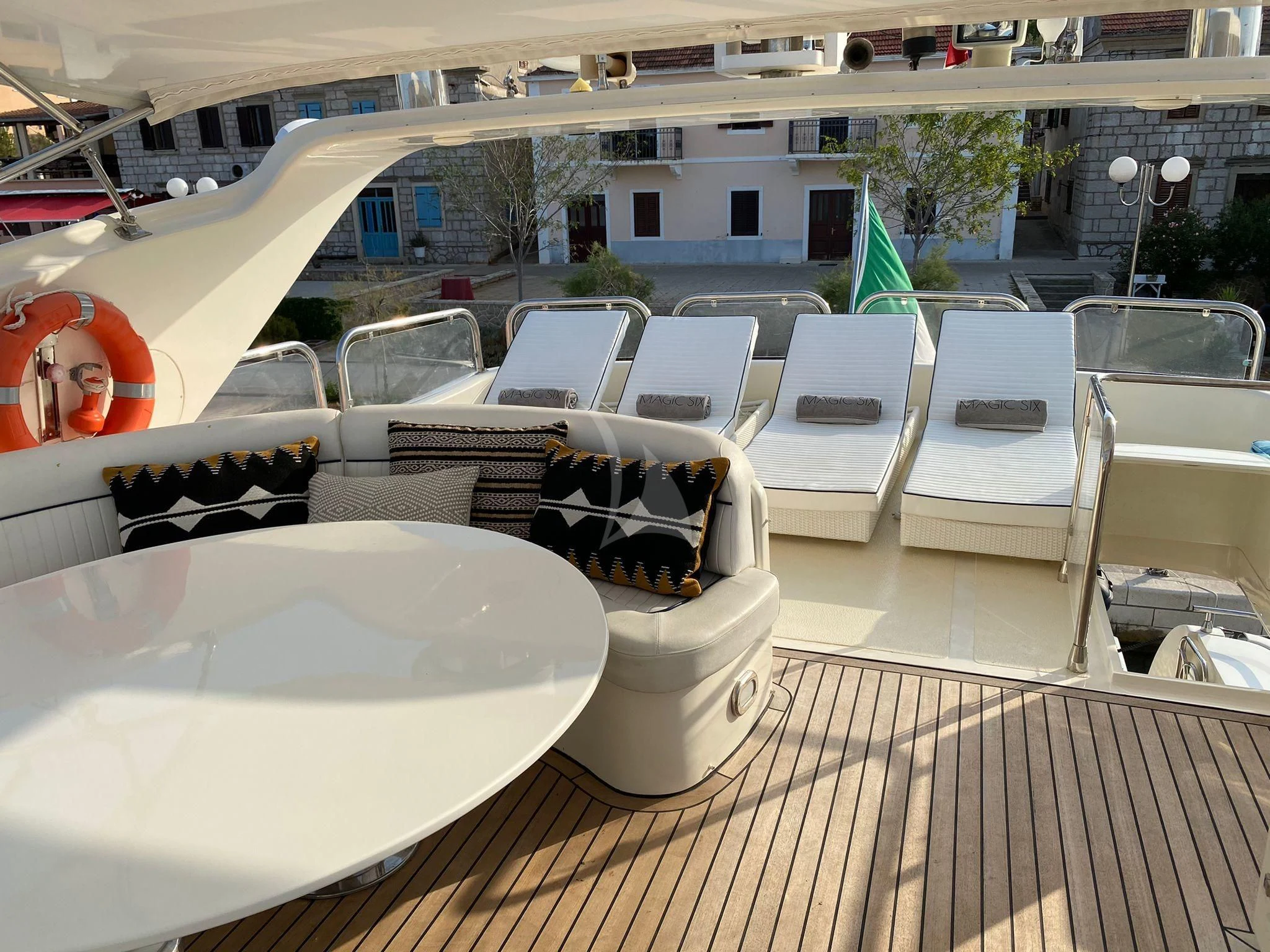 a patio with chairs and tables aboard MAGIC SIX Yacht for Sale