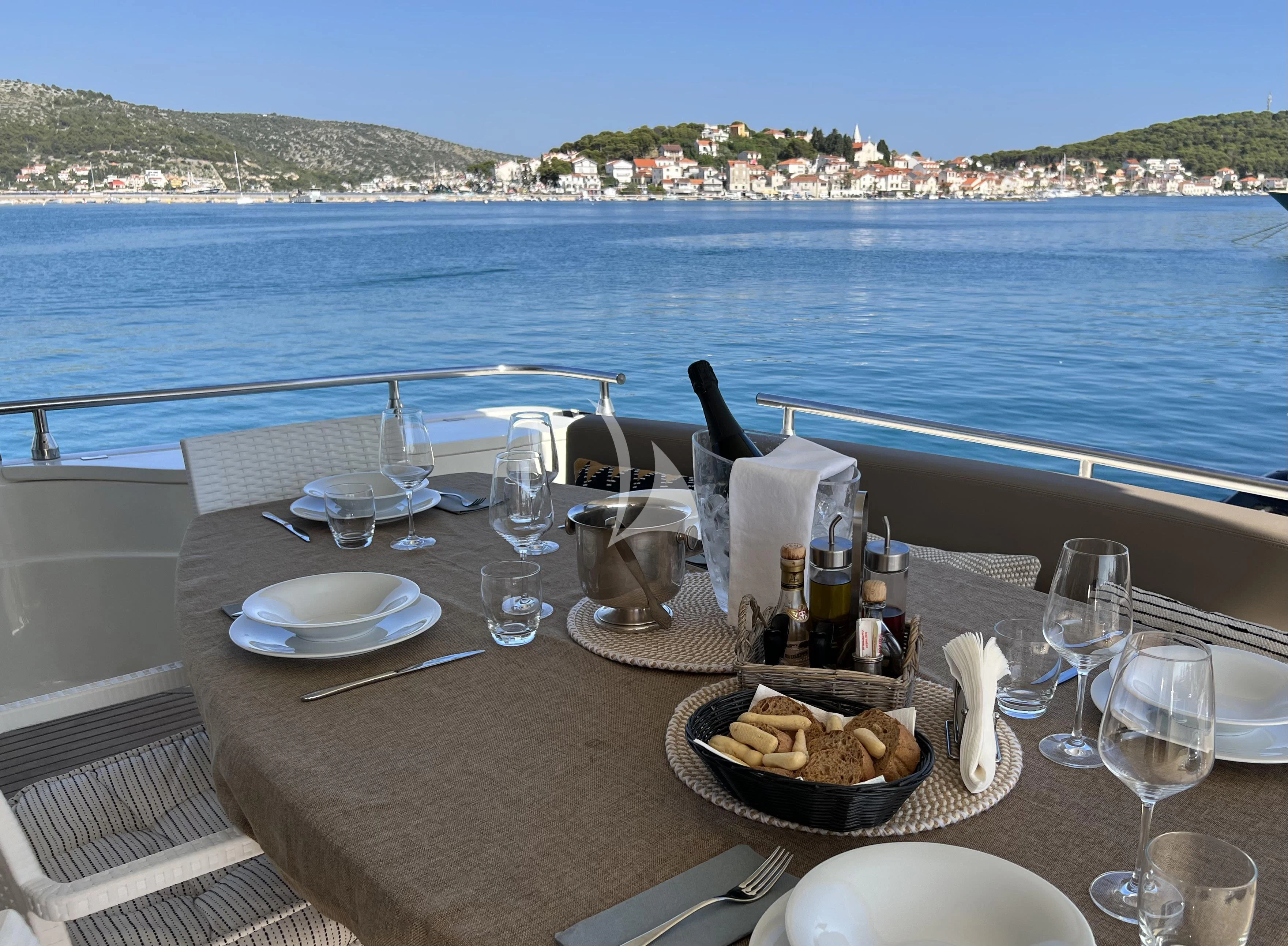 a table with food and wine on it aboard MAGIC SIX Yacht for Sale