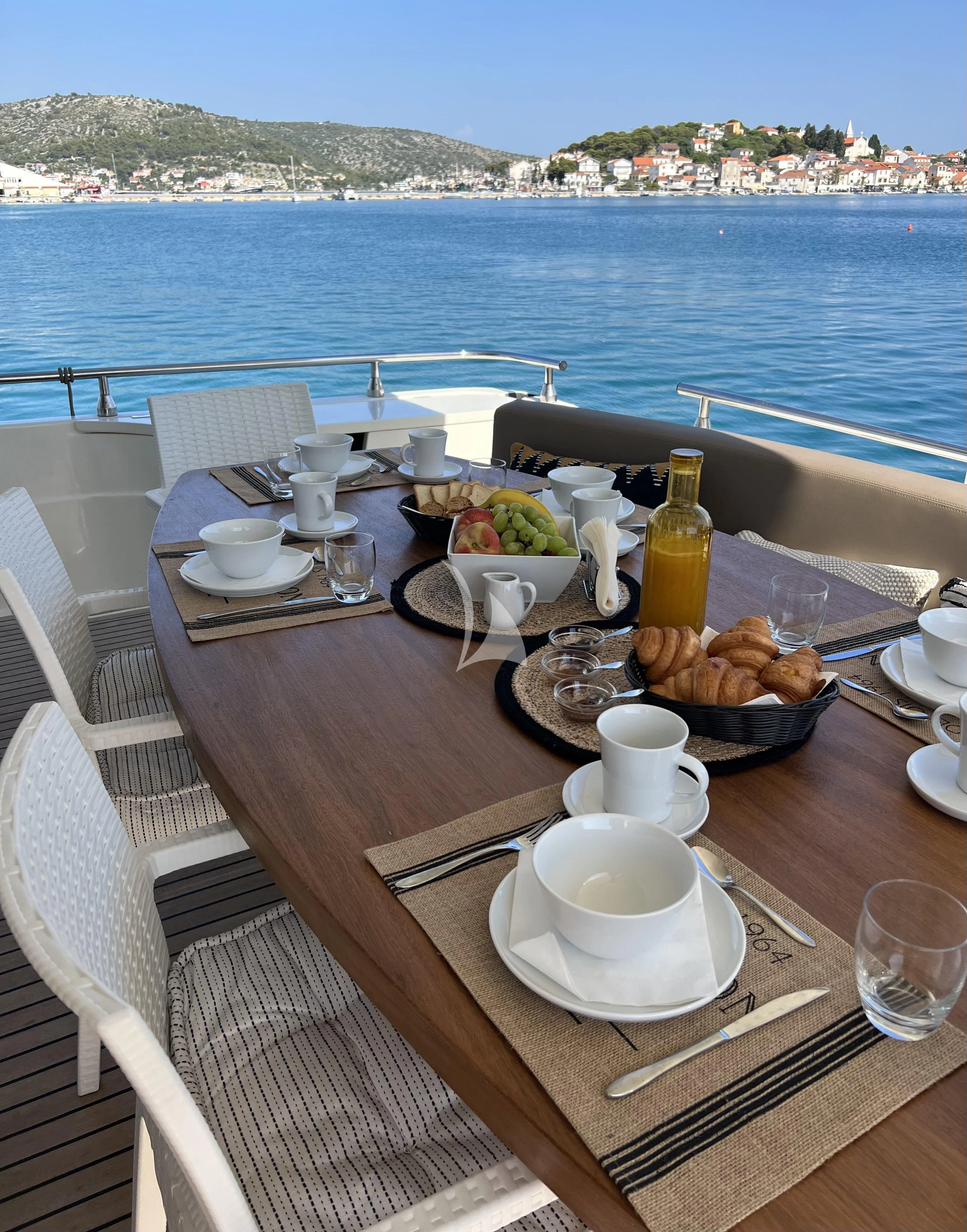 a table with food on it aboard MAGIC SIX Yacht for Sale