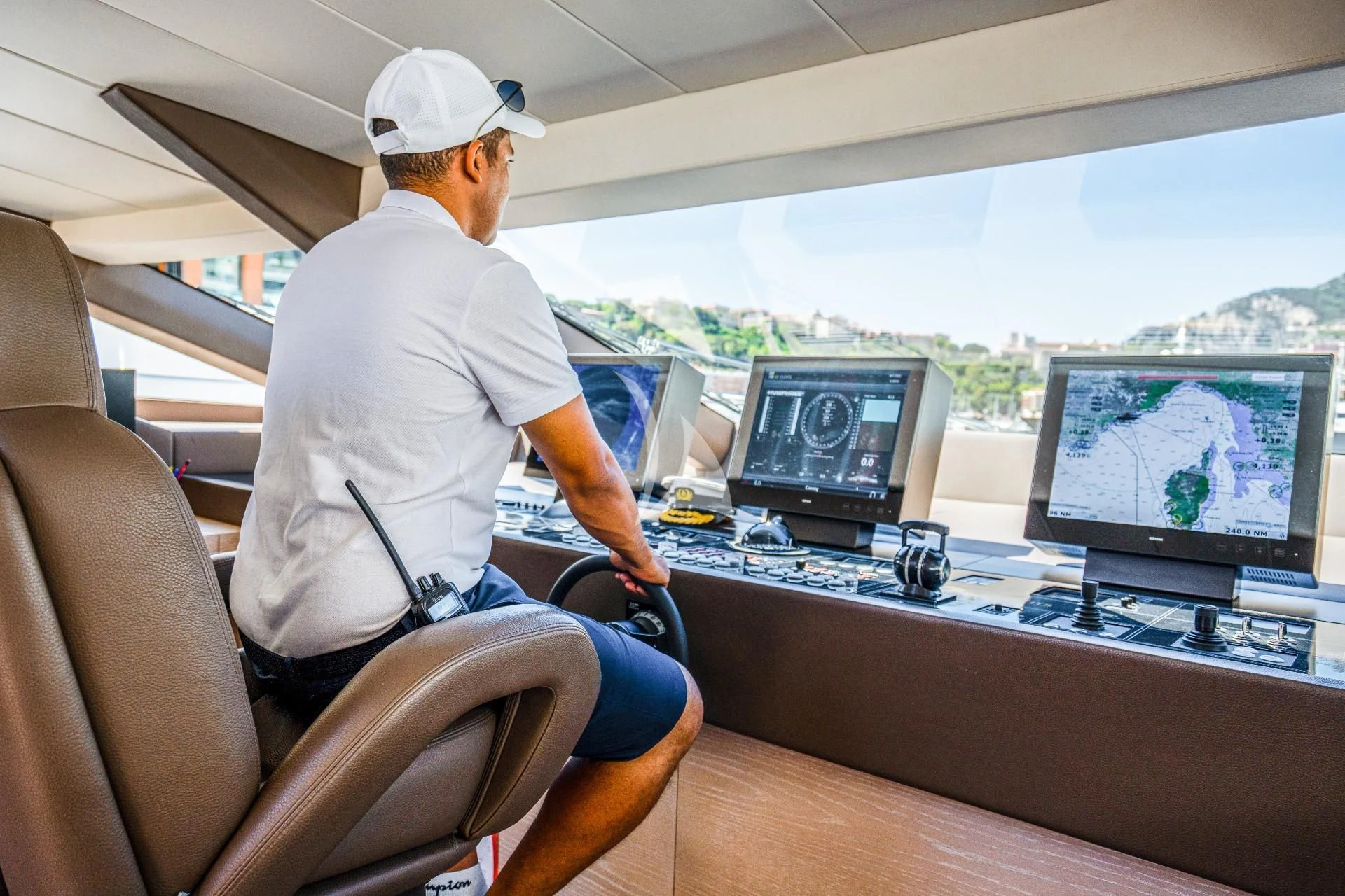 a man sitting in a chair in front of a computer aboard FAST & FURIOUS Yacht for Charter