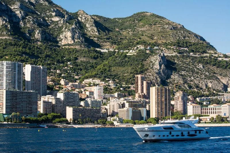 a boat on the water by a city on a hill aboard FAST & FURIOUS Yacht for Charter
