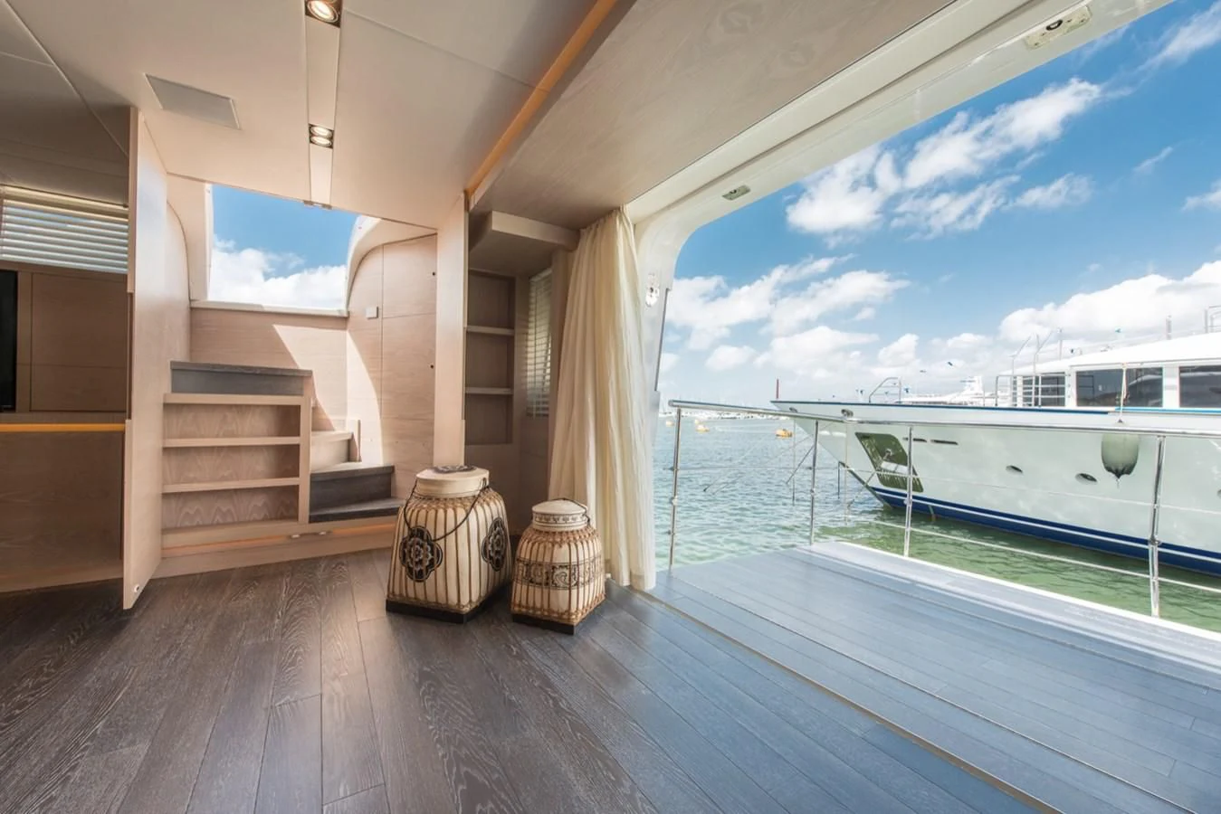 a room with a balcony and a pool aboard FAST & FURIOUS Yacht for Charter