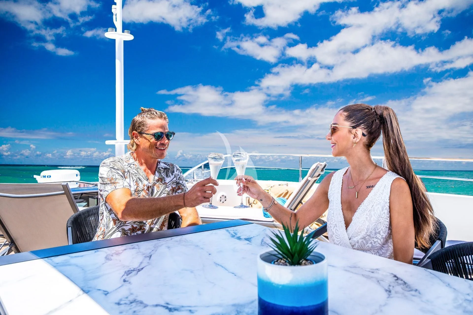 a man and woman drinking wine on a boat aboard FAST & FURIOUS Yacht for Charter