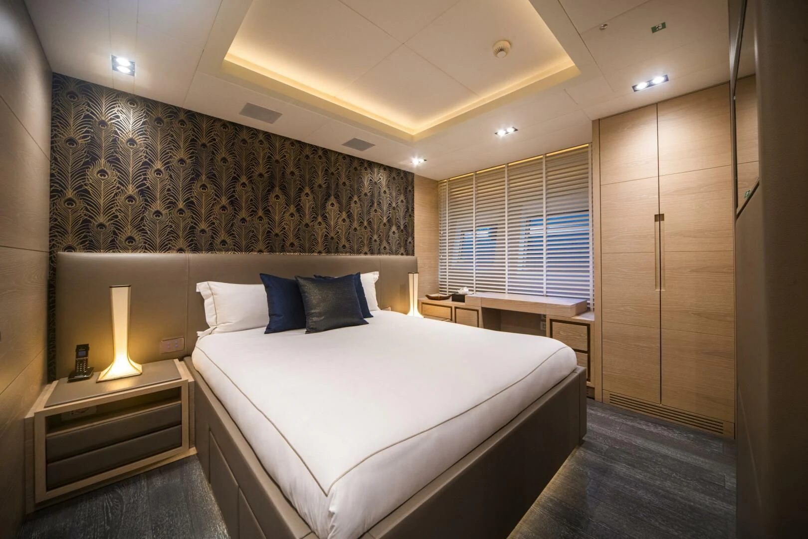 a bed with a white bed spread aboard FAST & FURIOUS Yacht for Charter