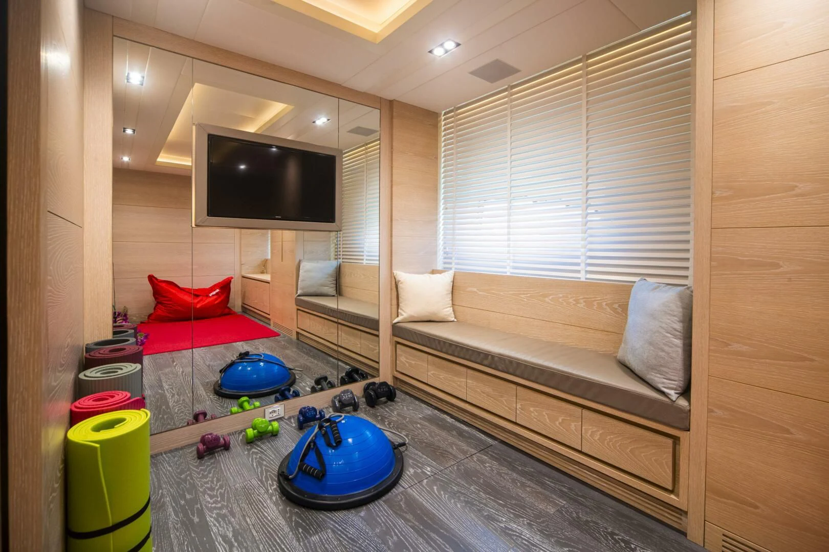 a living room with a couch and a tv aboard FAST & FURIOUS Yacht for Charter