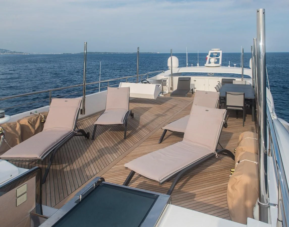 a deck with chairs and a large body of water in the background aboard FAST & FURIOUS Yacht for Charter