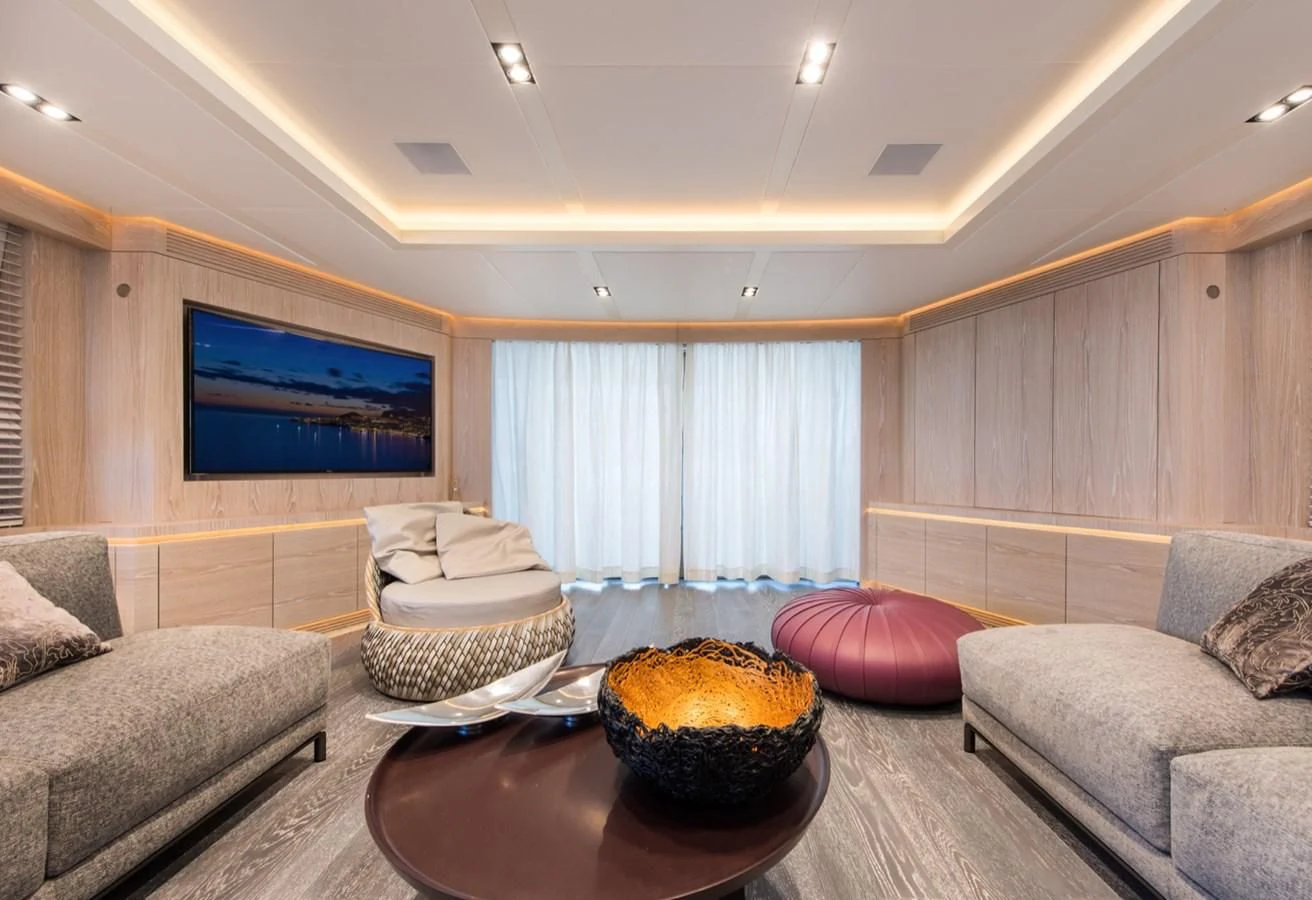 a living room with a couch and a table aboard FAST & FURIOUS Yacht for Charter