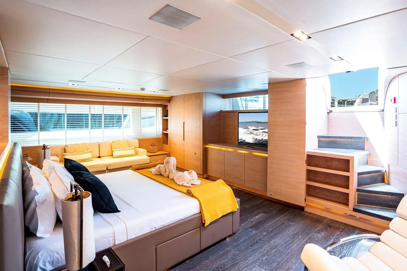 a room with a bed and a couch aboard FAST & FURIOUS Yacht for Charter