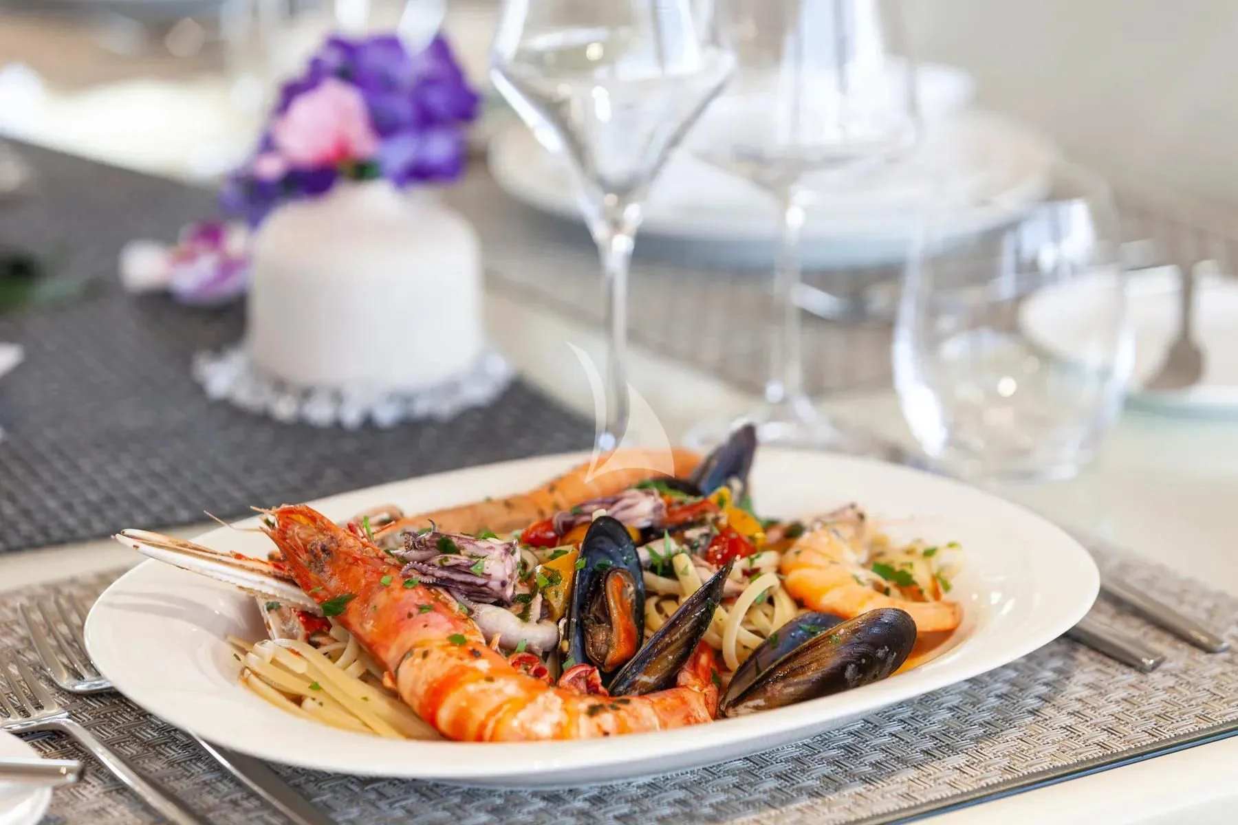 a plate of food and glasses aboard FAST & FURIOUS Yacht for Charter