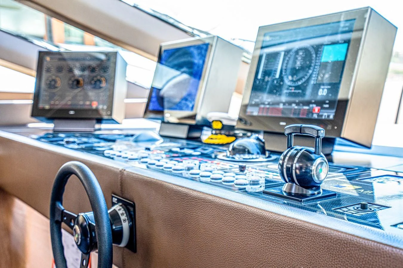 a computer with a few monitors and a few electronic devices aboard FAST & FURIOUS Yacht for Charter