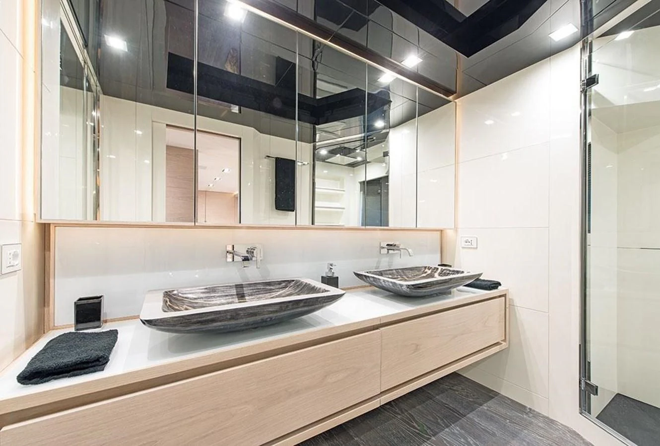 a bathroom with a sink and a phone on the counter aboard FAST & FURIOUS Yacht for Charter