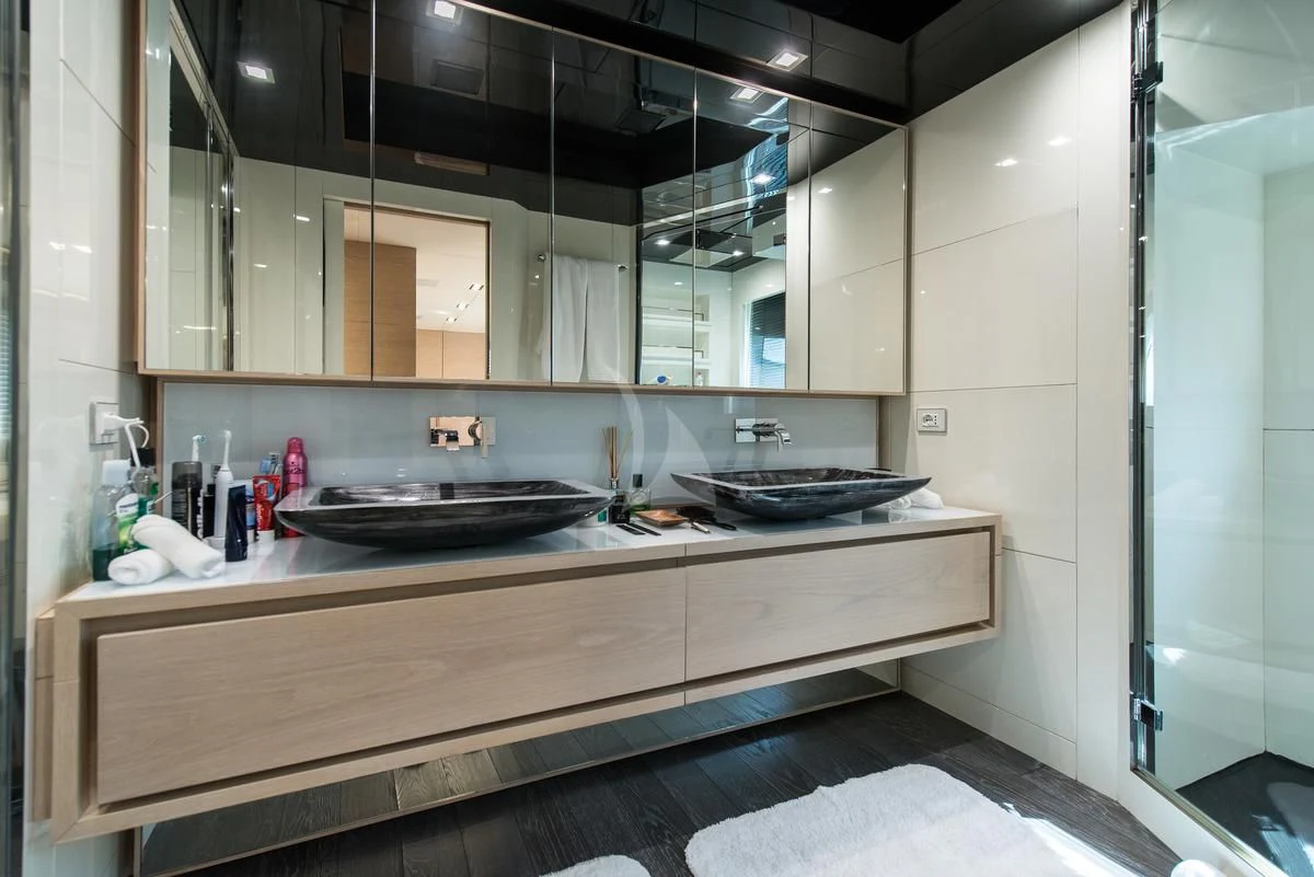 a kitchen with a sink and a large mirror aboard FAST & FURIOUS Yacht for Charter