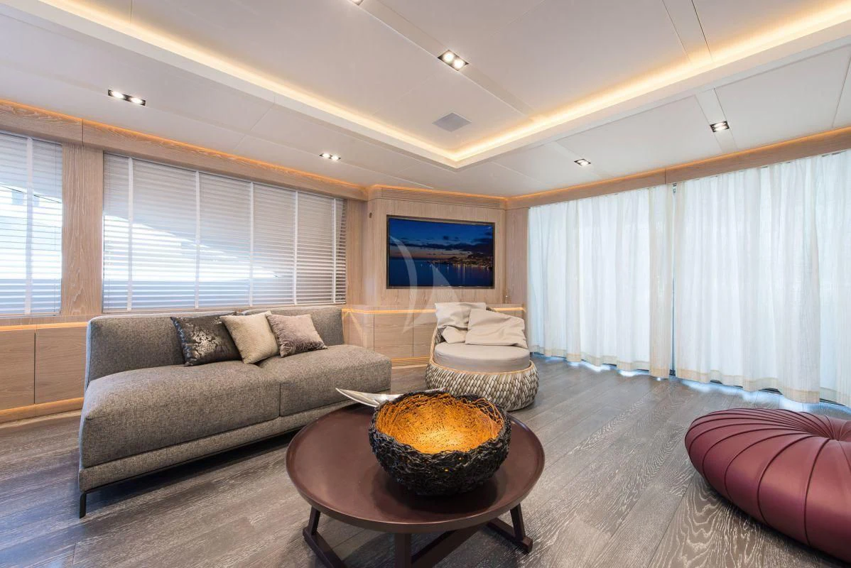 a living room with a couch and a coffee table aboard FAST & FURIOUS Yacht for Charter