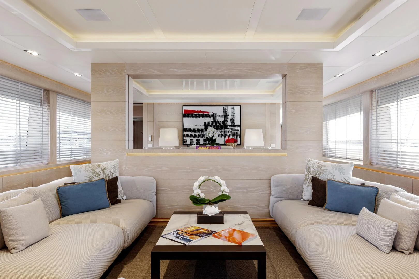 a living room with white couches aboard FAST & FURIOUS Yacht for Charter