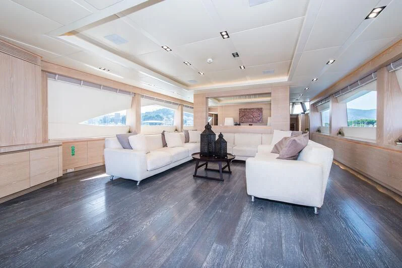 a living room with a large wood floor aboard FAST & FURIOUS Yacht for Charter