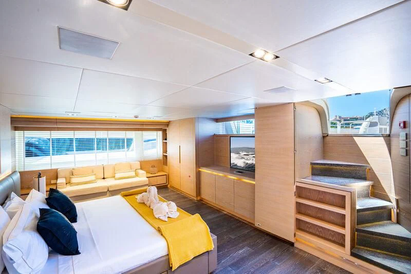 a room with a bed and a table aboard FAST & FURIOUS Yacht for Charter