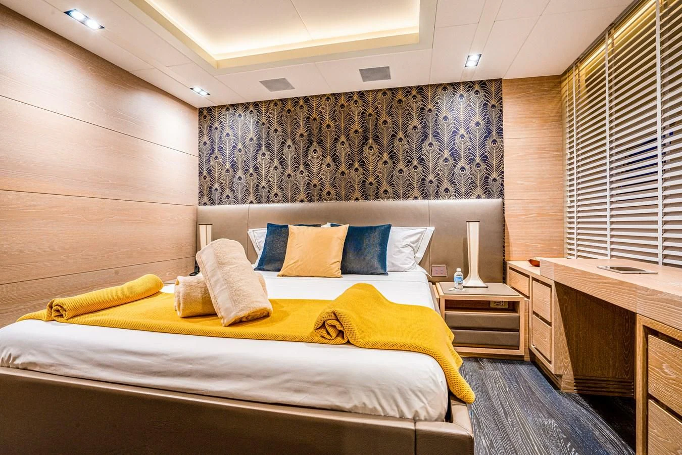 a room with a bed and a desk aboard FAST & FURIOUS Yacht for Charter
