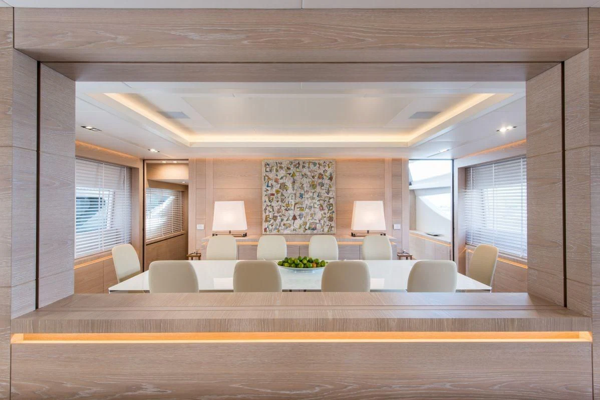 a large room with a couch and a table aboard FAST & FURIOUS Yacht for Charter