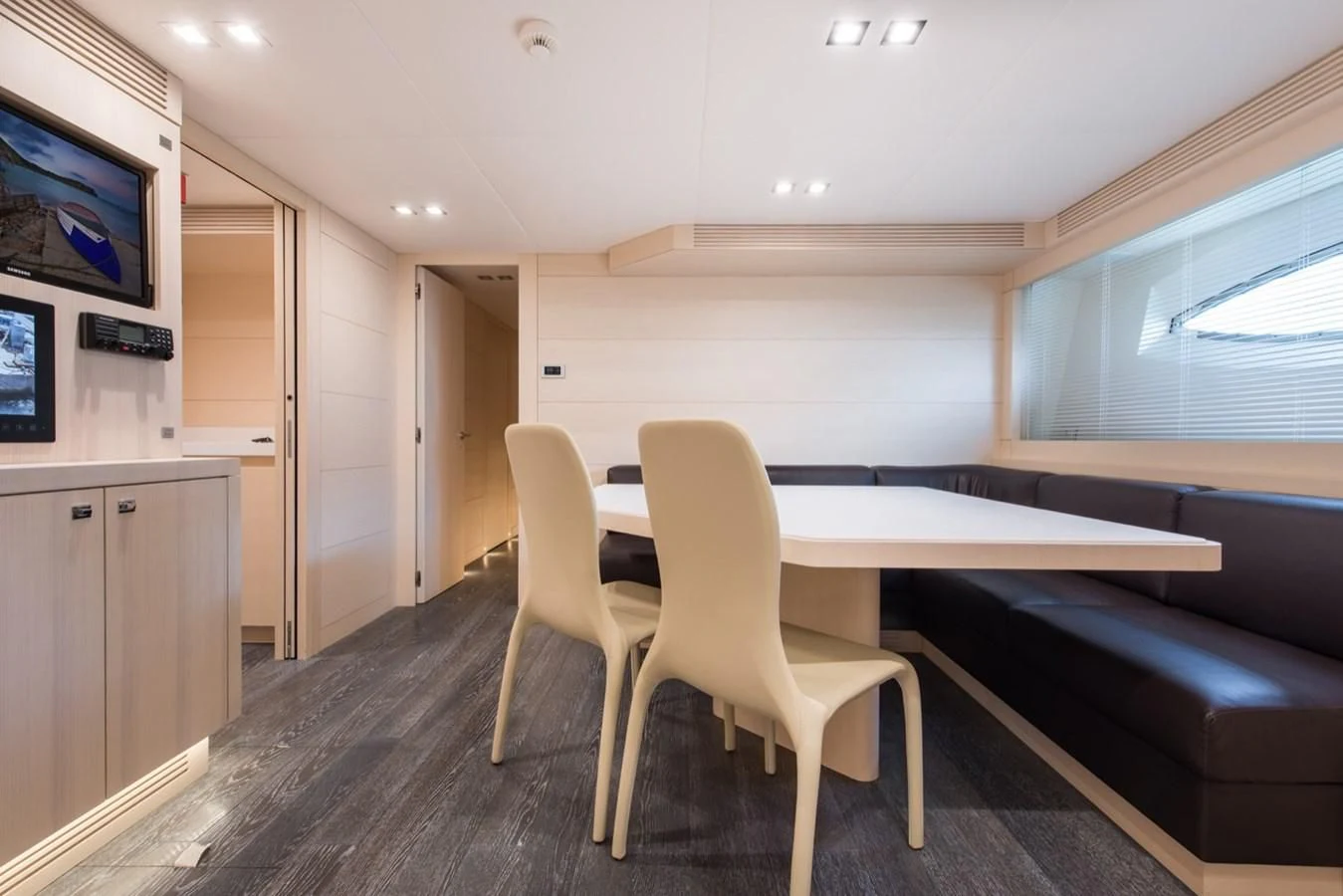 a room with a table and chairs aboard FAST & FURIOUS Yacht for Charter