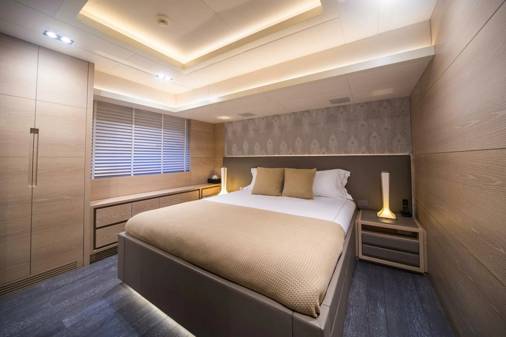 a room with a bed and a desk aboard FAST & FURIOUS Yacht for Charter