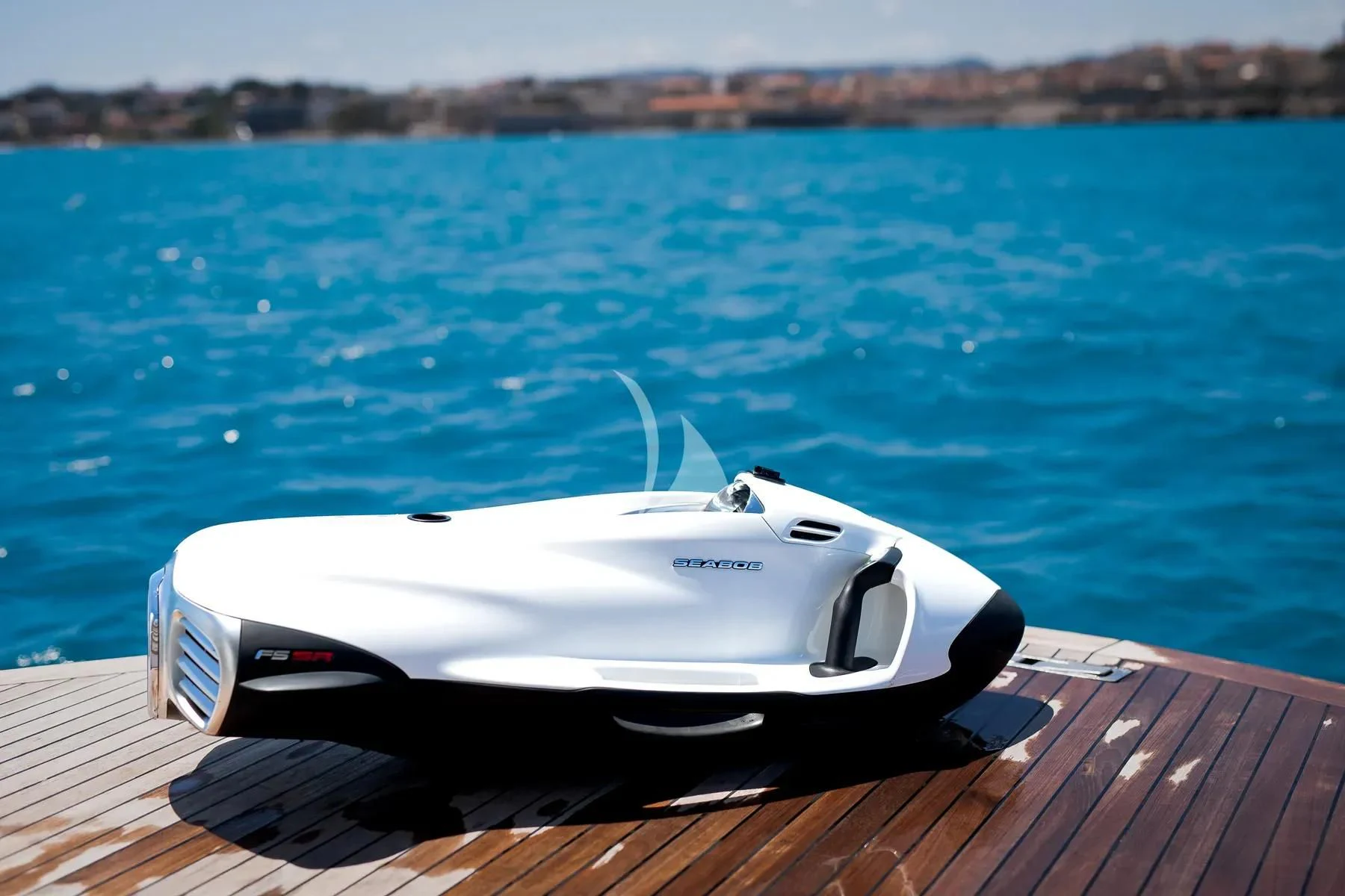 a white sports car on a dock aboard FAST & FURIOUS Yacht for Charter