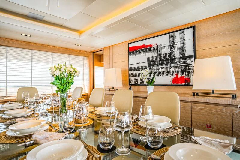 a dining room with tables and chairs aboard FAST & FURIOUS Yacht for Charter