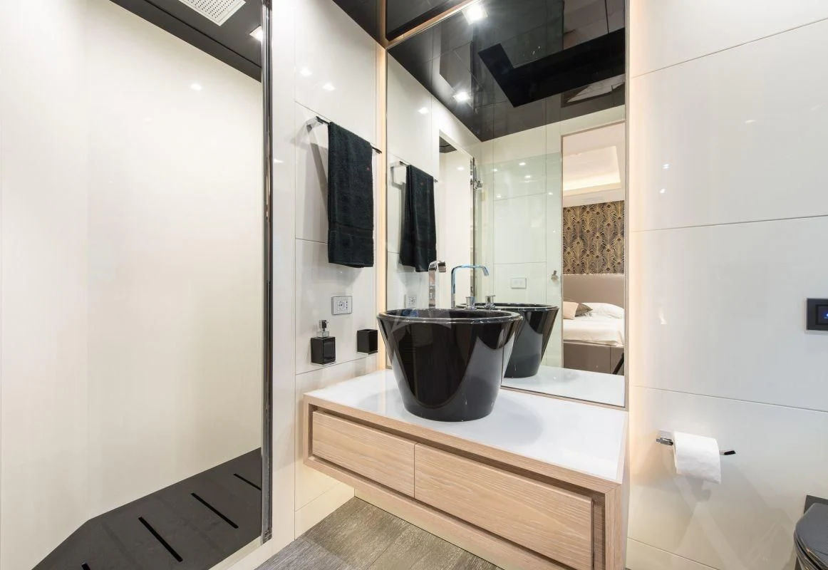 a bathroom with a large black bowl aboard FAST & FURIOUS Yacht for Charter